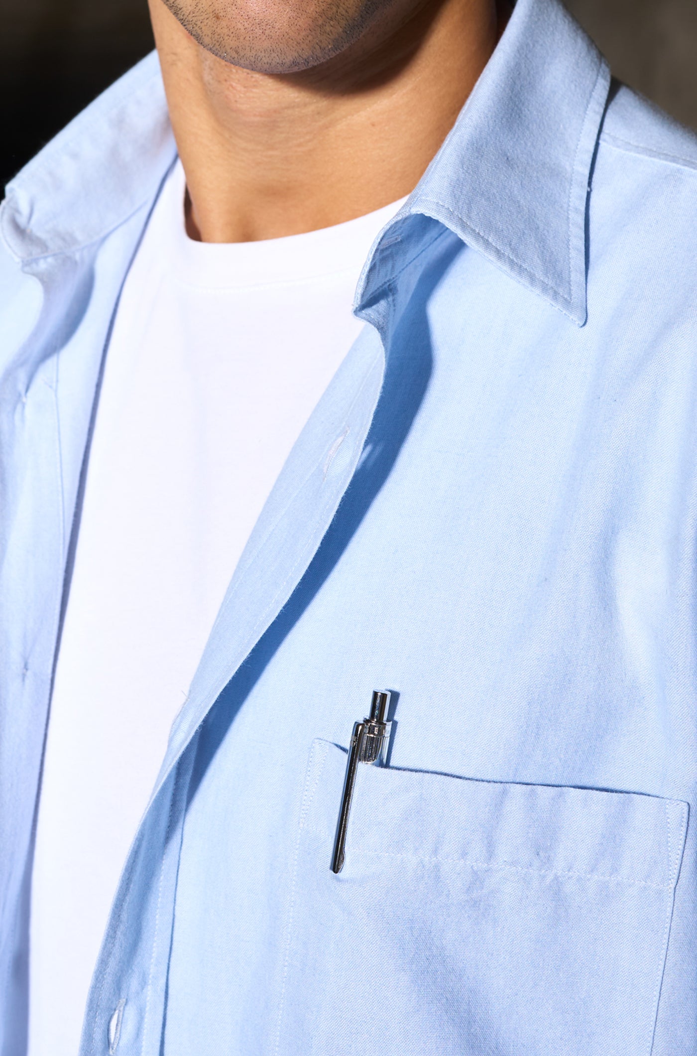 Close-up of a silver metallic pen engraved with "THE CLUB" and a small FC Barcelona logo.