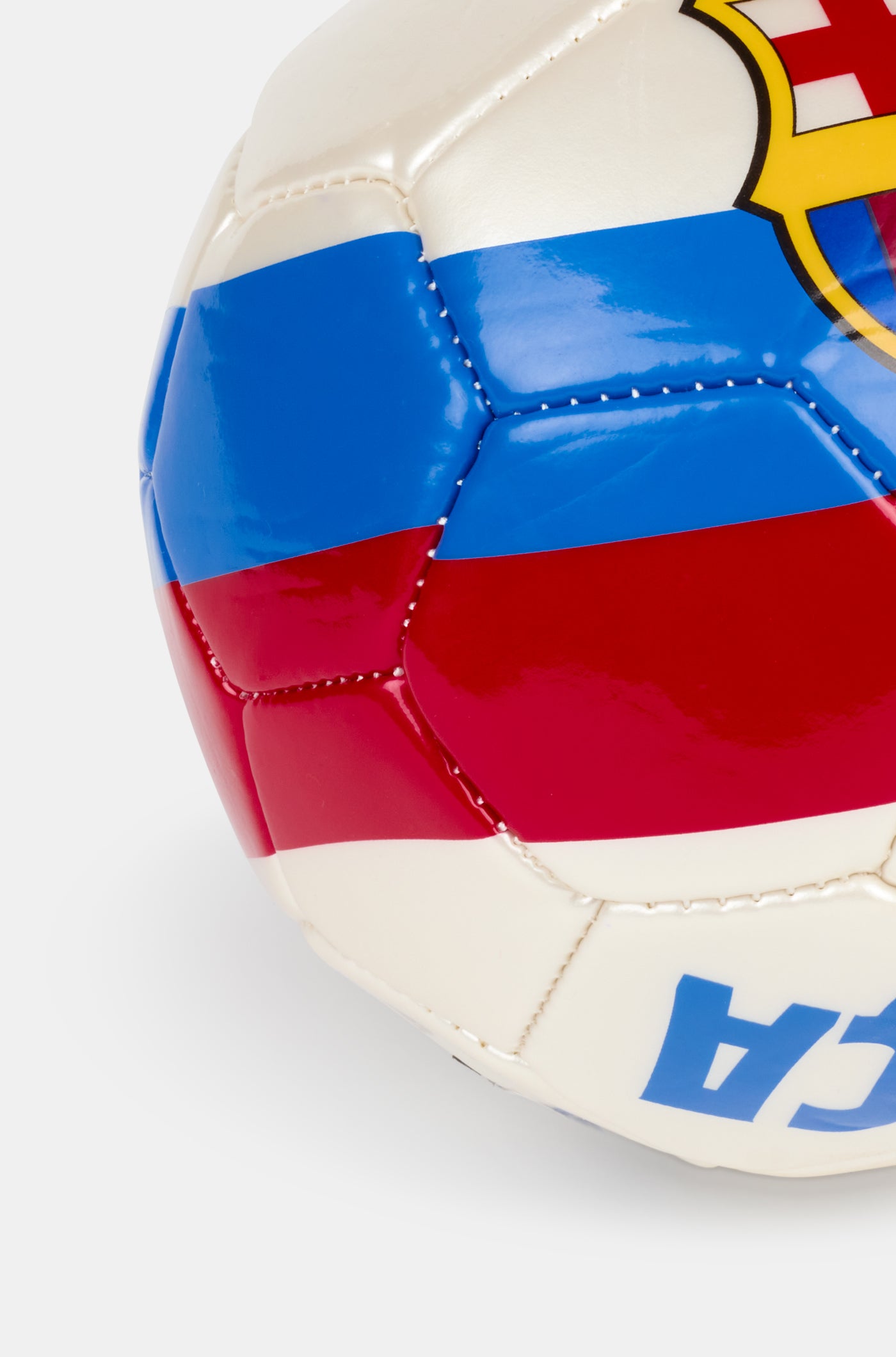 White football with blue and red stripes, featuring a large FC Barcelona crest in the center