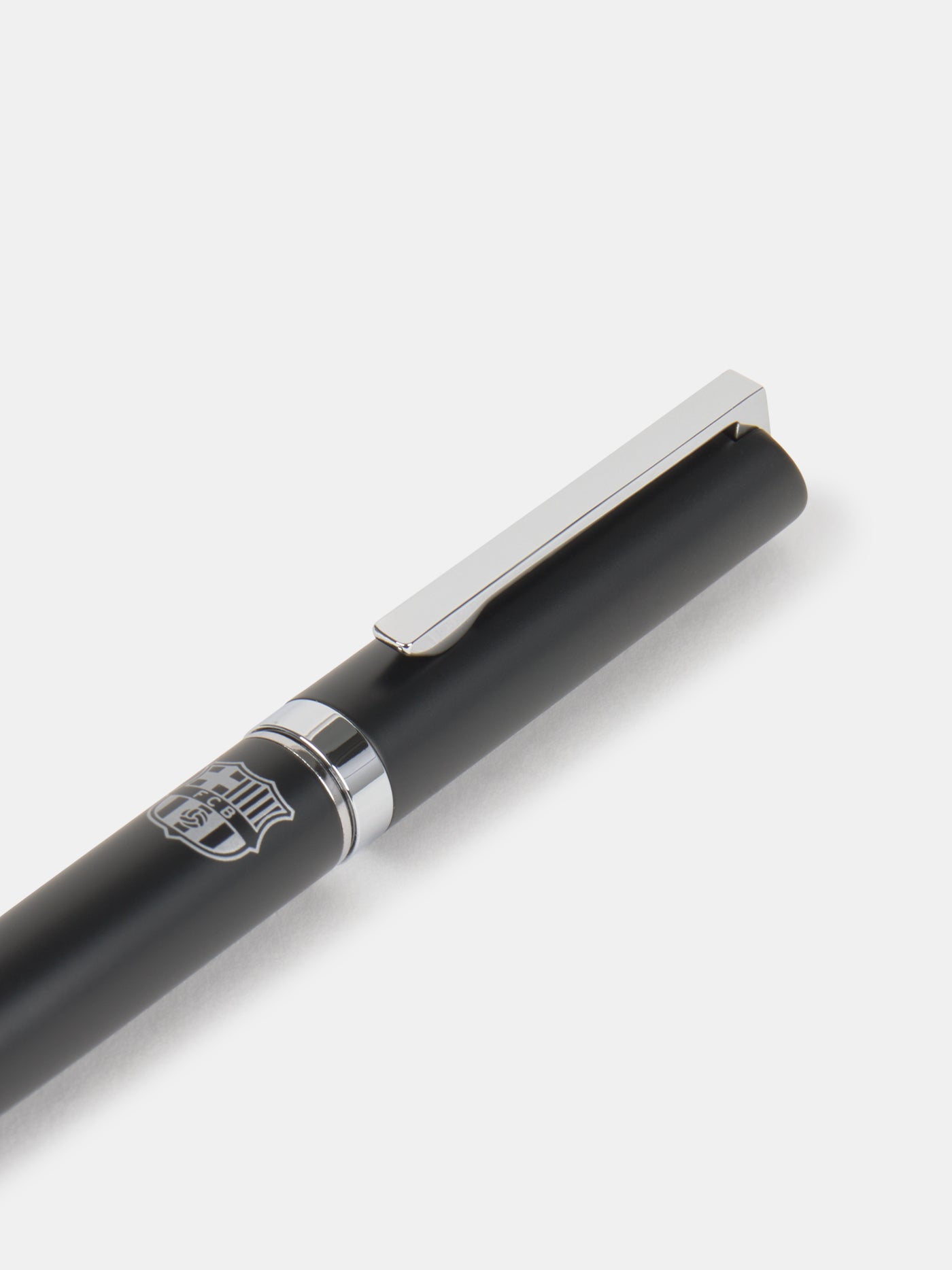 Black and silver pen featuring an engraved FC Barcelona crest on the barrel.