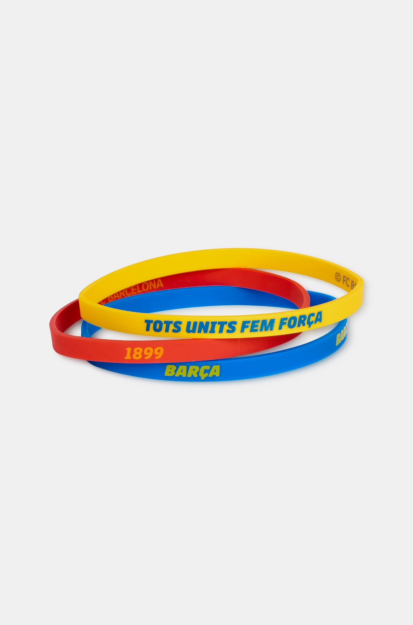 Set of three silicone wristbands in blue, red, and yellow, featuring FC Barcelona-related texts like 'BARÇA', '1899', and 'TOTS UNITS FEM FORÇA