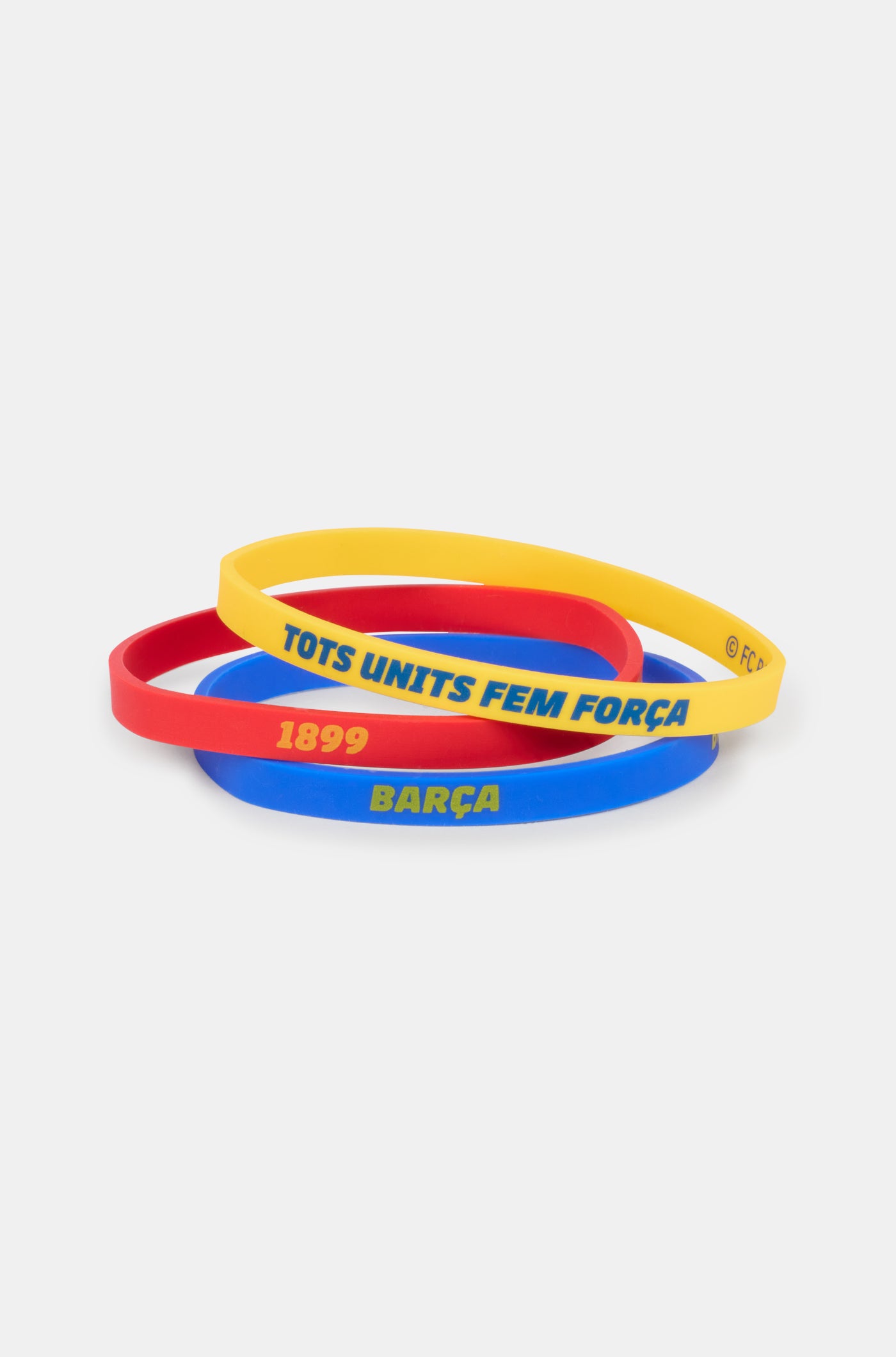 Set of three silicone wristbands in blue, red, and yellow, featuring FC Barcelona-related texts like 'BARÇA', '1899', and 'TOTS UNITS FEM FORÇA