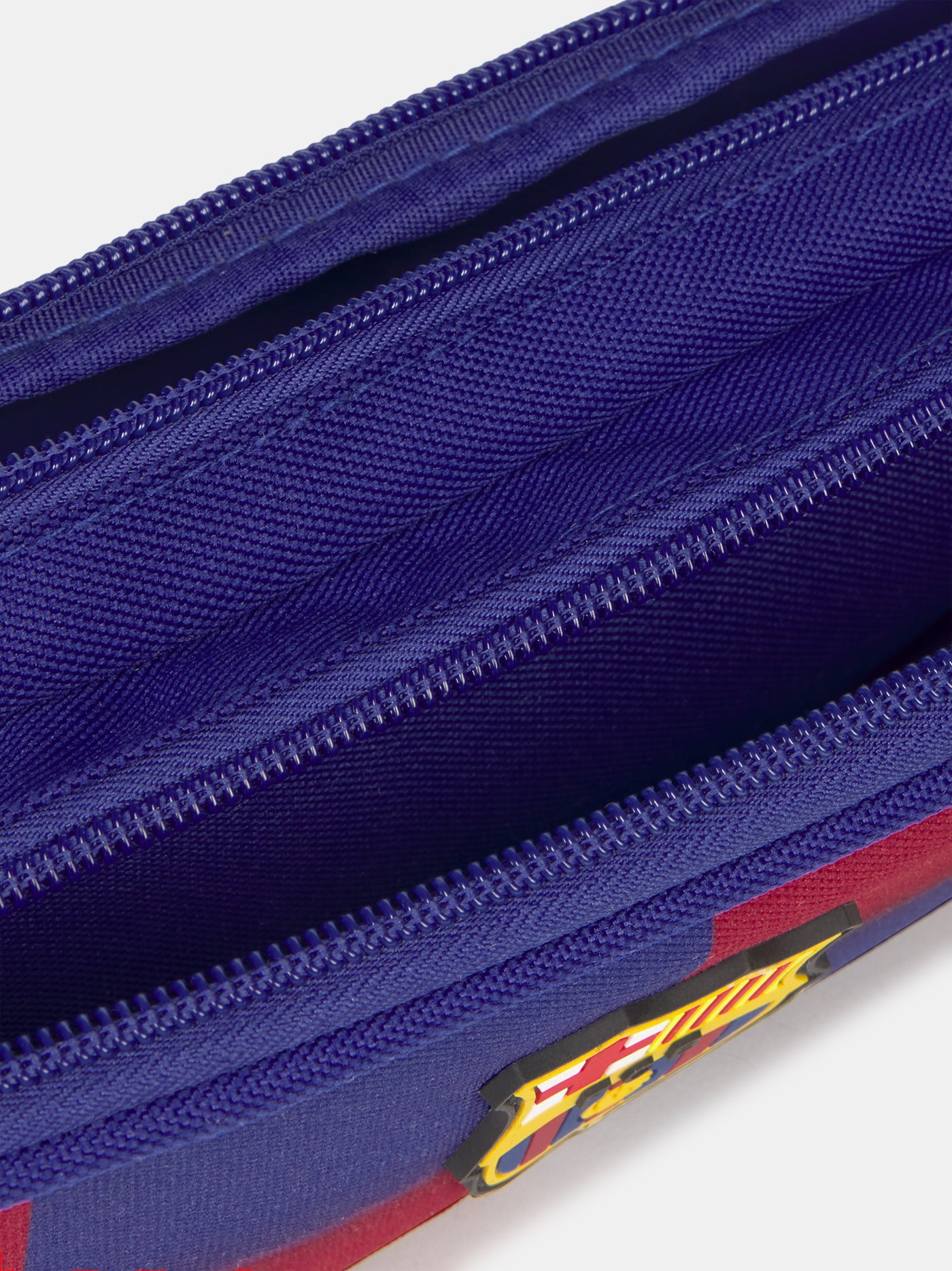 Close-up of a blue and red zipper with a logo on a white background