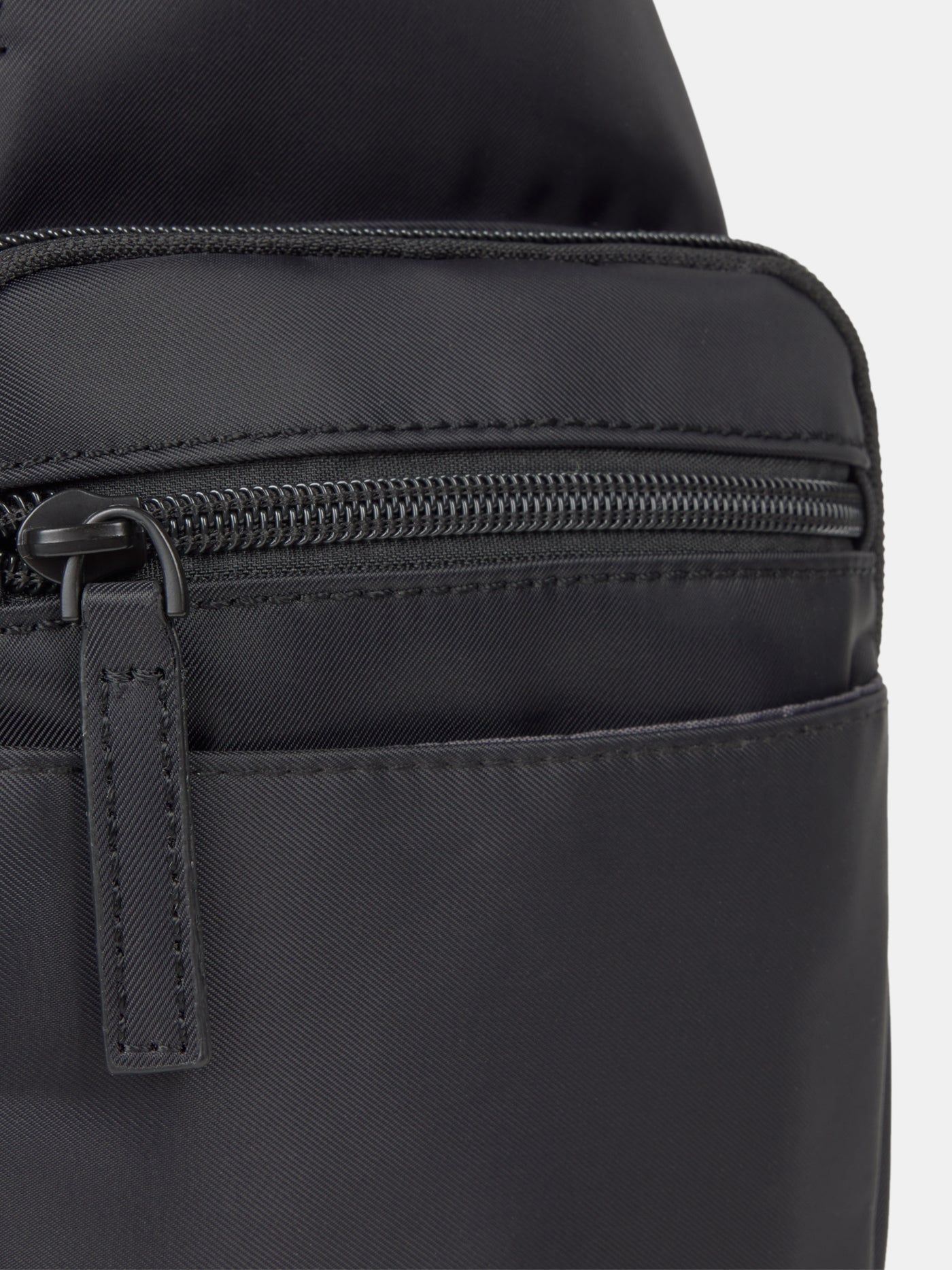 Black FC Barcelona crossbody bag with multiple zippered compartments and metallic club crest on the front pocket.