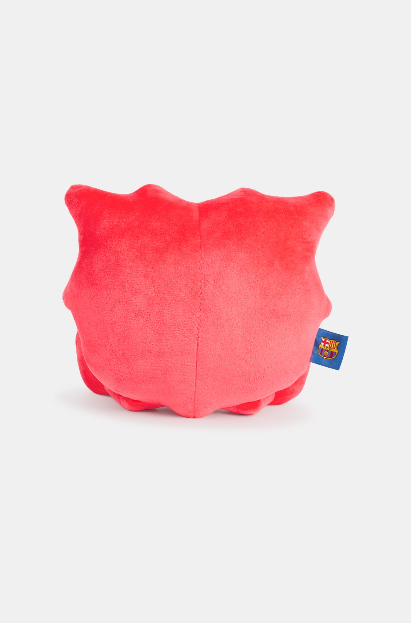 Red plush toy with a smiling face, featuring the FC Barcelona crest on one foot and a club tag on the side