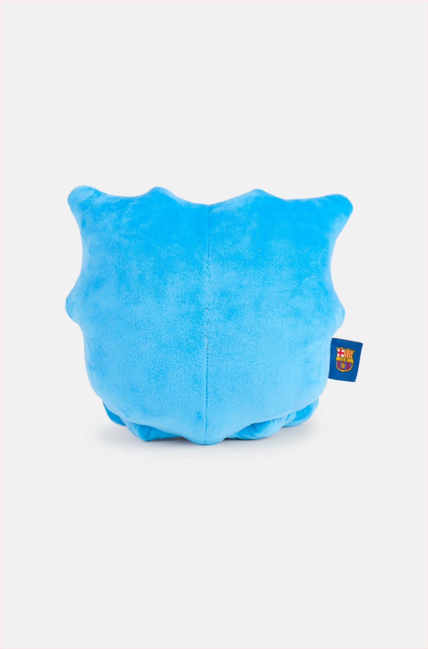 Blue plush toy with big eyes and a small smile, featuring the FC Barcelona crest on one foot and a club tag on the side
