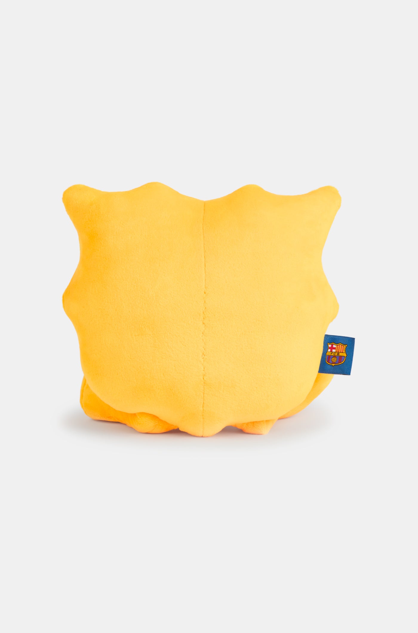Yellow plush toy with a winking face and a wide smile, featuring the FC Barcelona crest on one foot and a club tag on the side