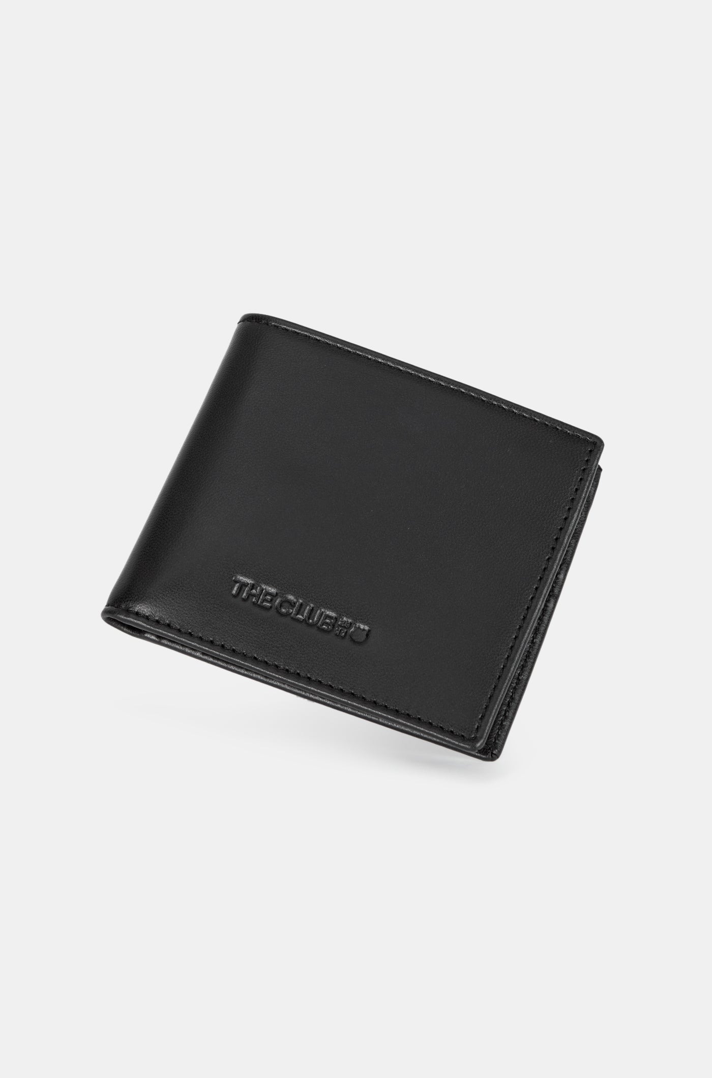 Close-up of a black leather wallet with an embossed FC Barcelona logo on the corner.