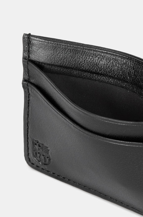 Black leather cardholder with embossed “THE CLUB” text on the front, featuring two horizontal card slots.