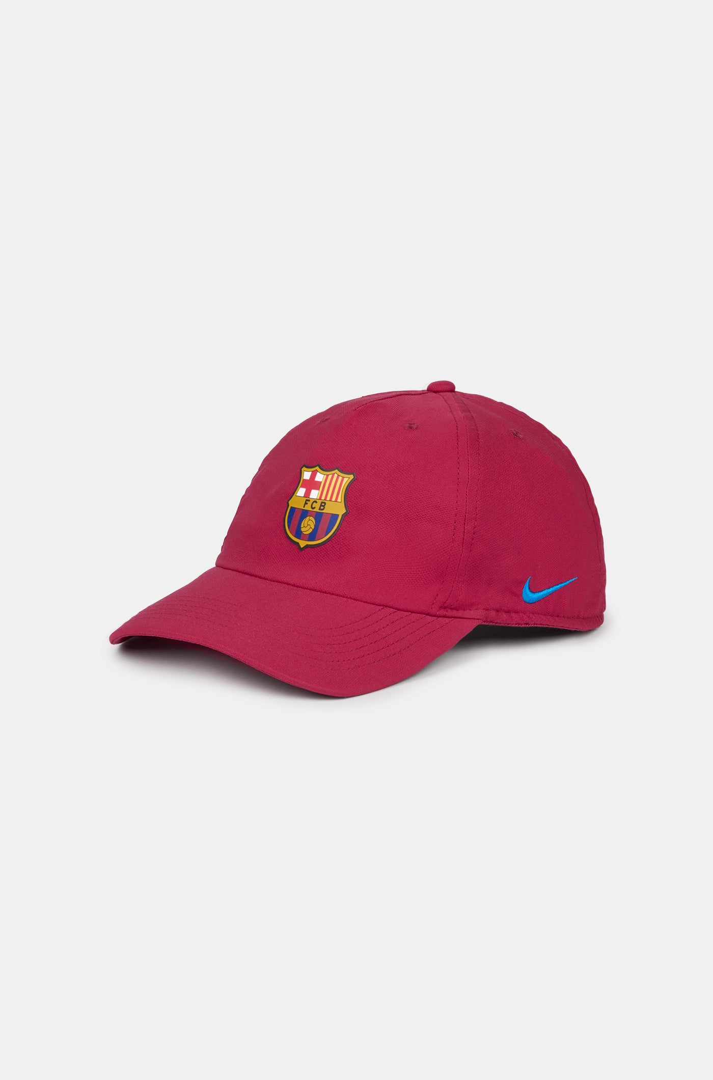 Red curved-brim cap featuring the FC Barcelona crest on the front and a blue Nike swoosh embroidered on the side.