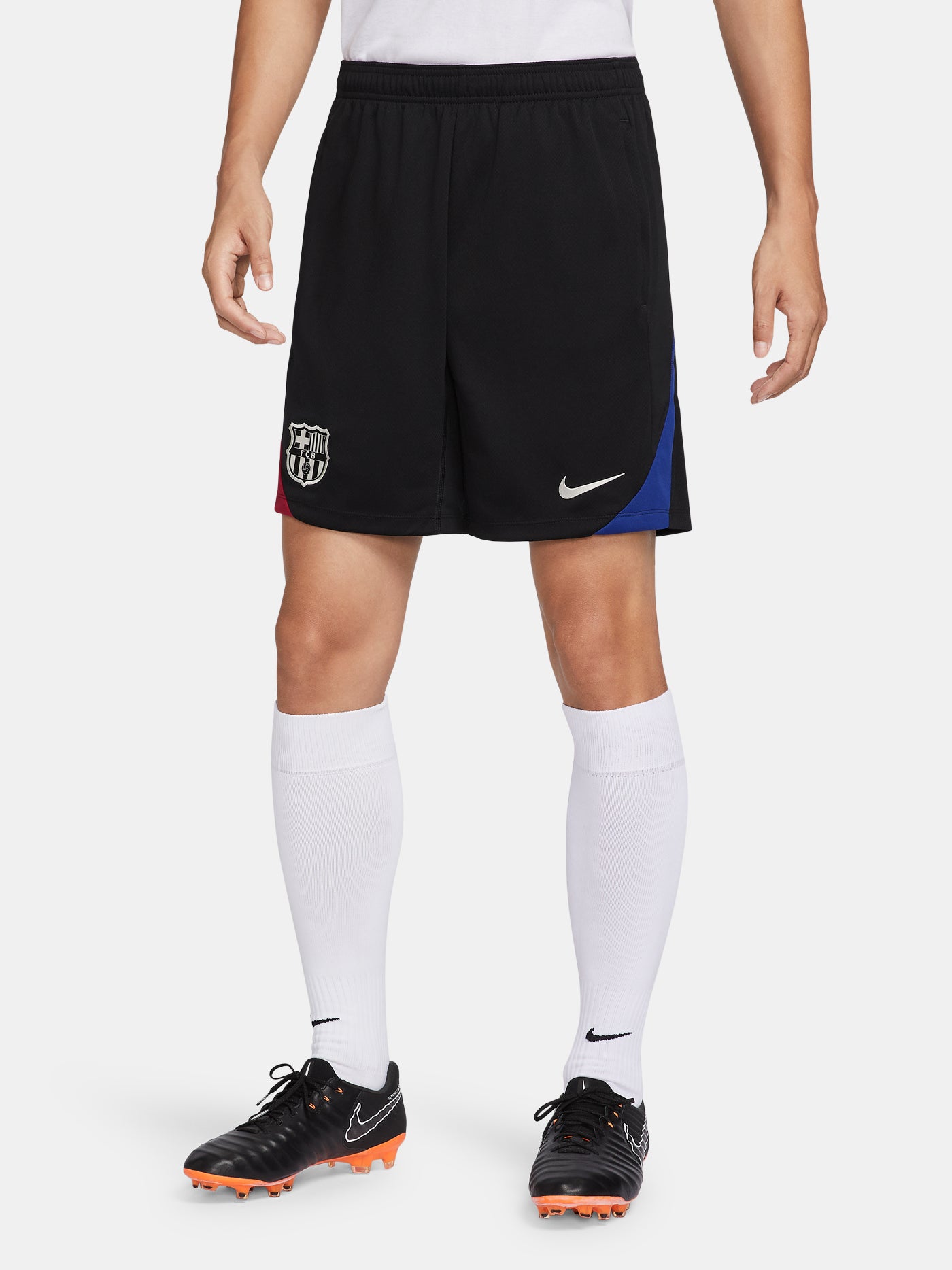 Black FC Barcelona shorts with blue and red side accents, Nike logo and club crest.