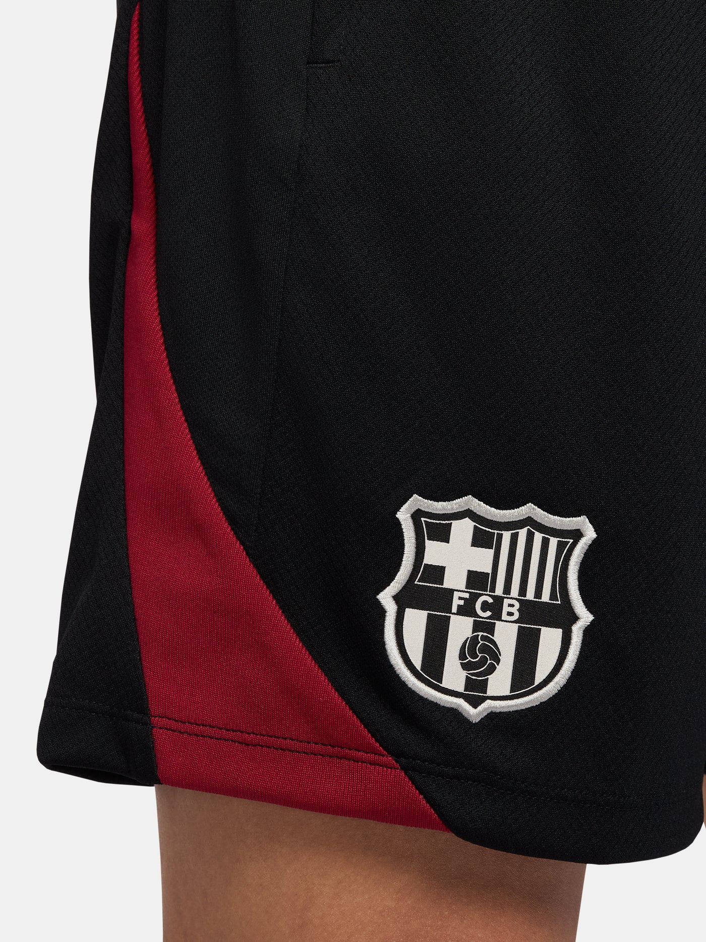 Black FC Barcelona shorts with blue and red side accents, Nike logo and club crest.