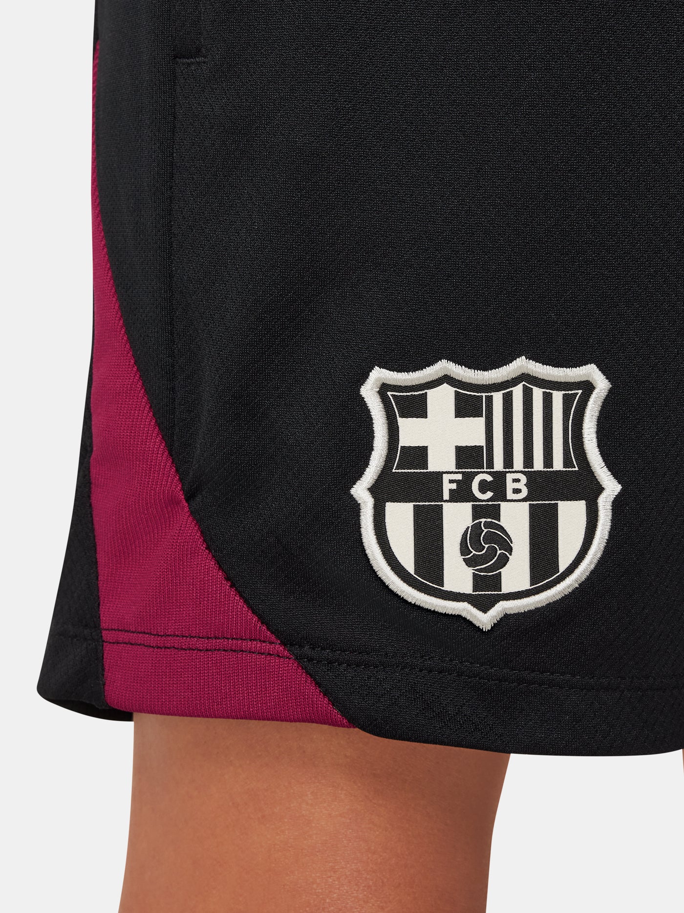 FC Barcelona kids' black shorts with white crest, Nike logo, and red-blue side accents.