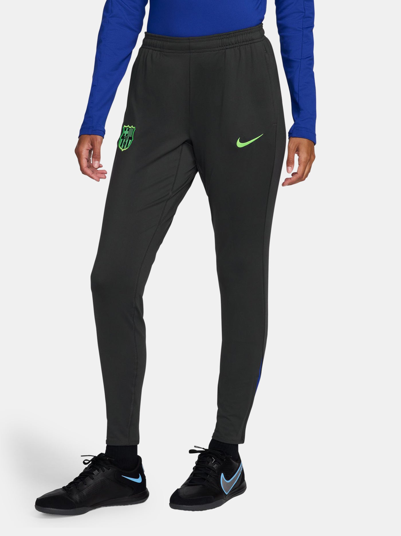 Black FC Barcelona track pants with neon green Nike logo and club crest.