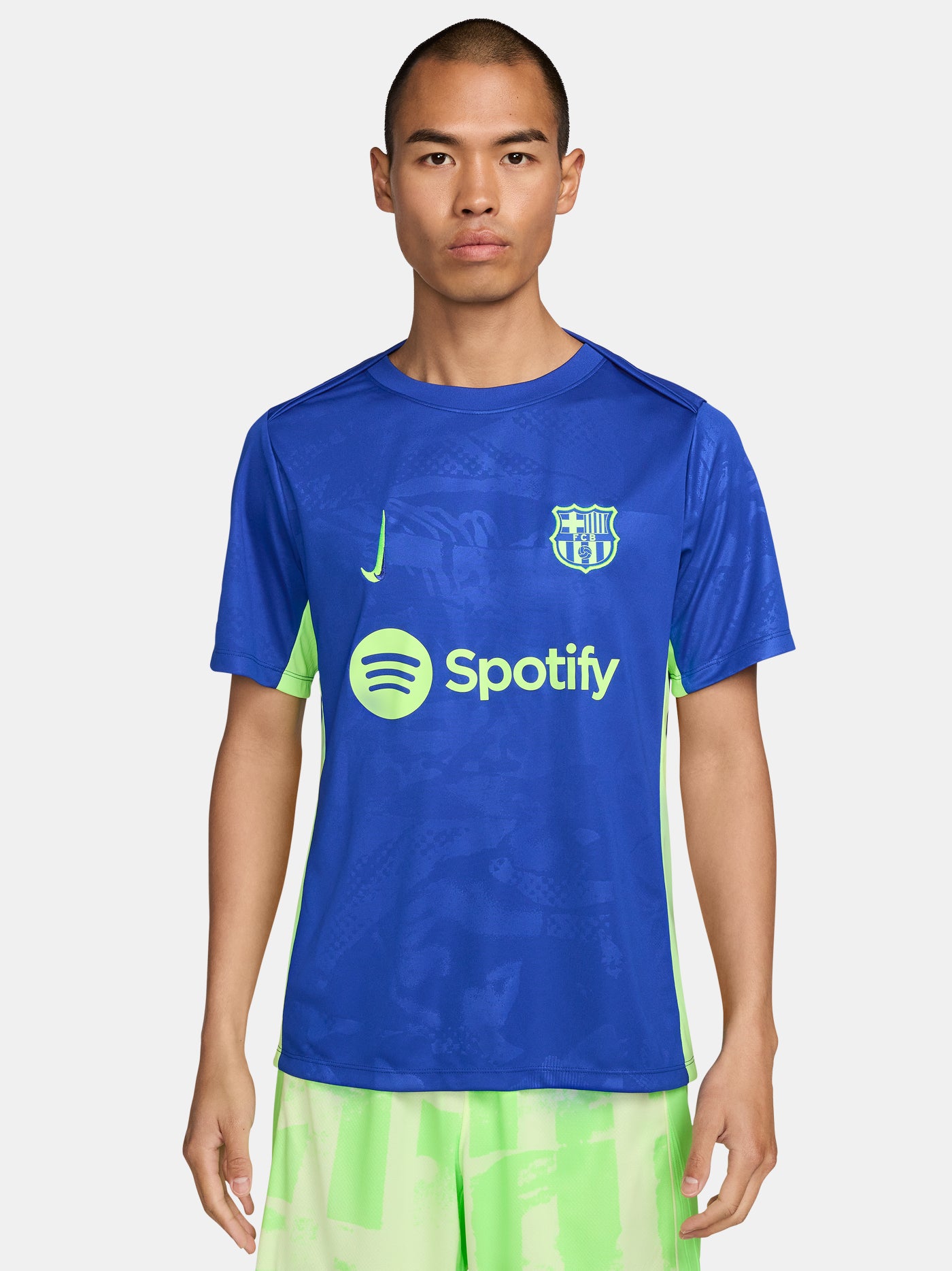 Blue and neon green FC Barcelona training jersey with Spotify and Nike logos.