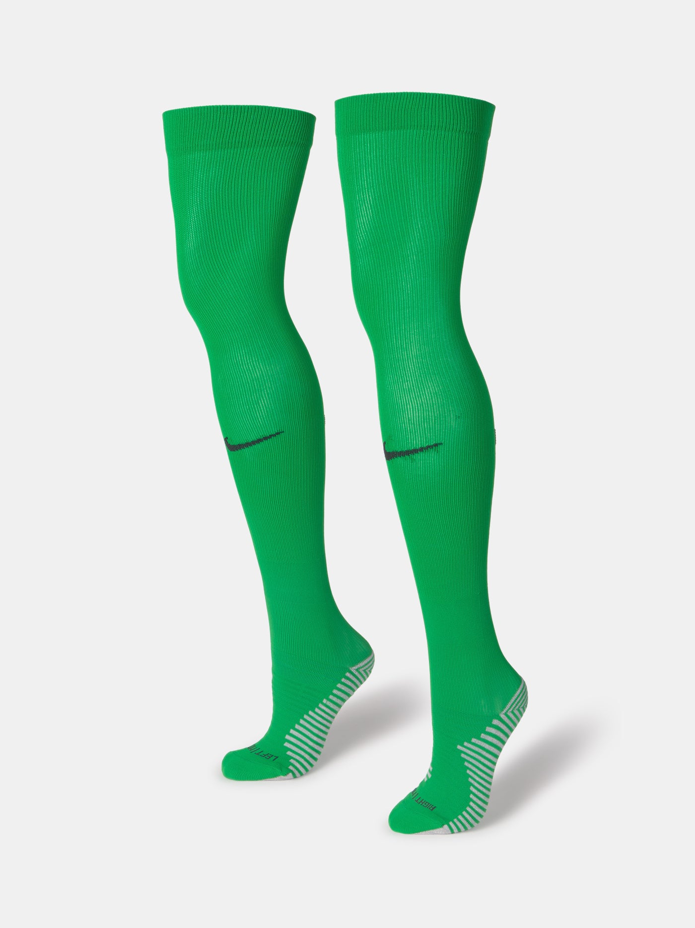Pair of green Nike over-the-knee football socks with black swoosh and cushioned sole