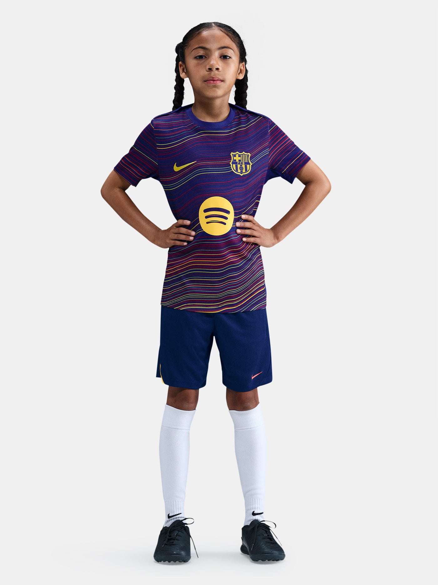 Junior FC Barcelona pre-match jersey with multicolor wave pattern, yellow Nike logo, club crest, and Spotify sponsor on the front