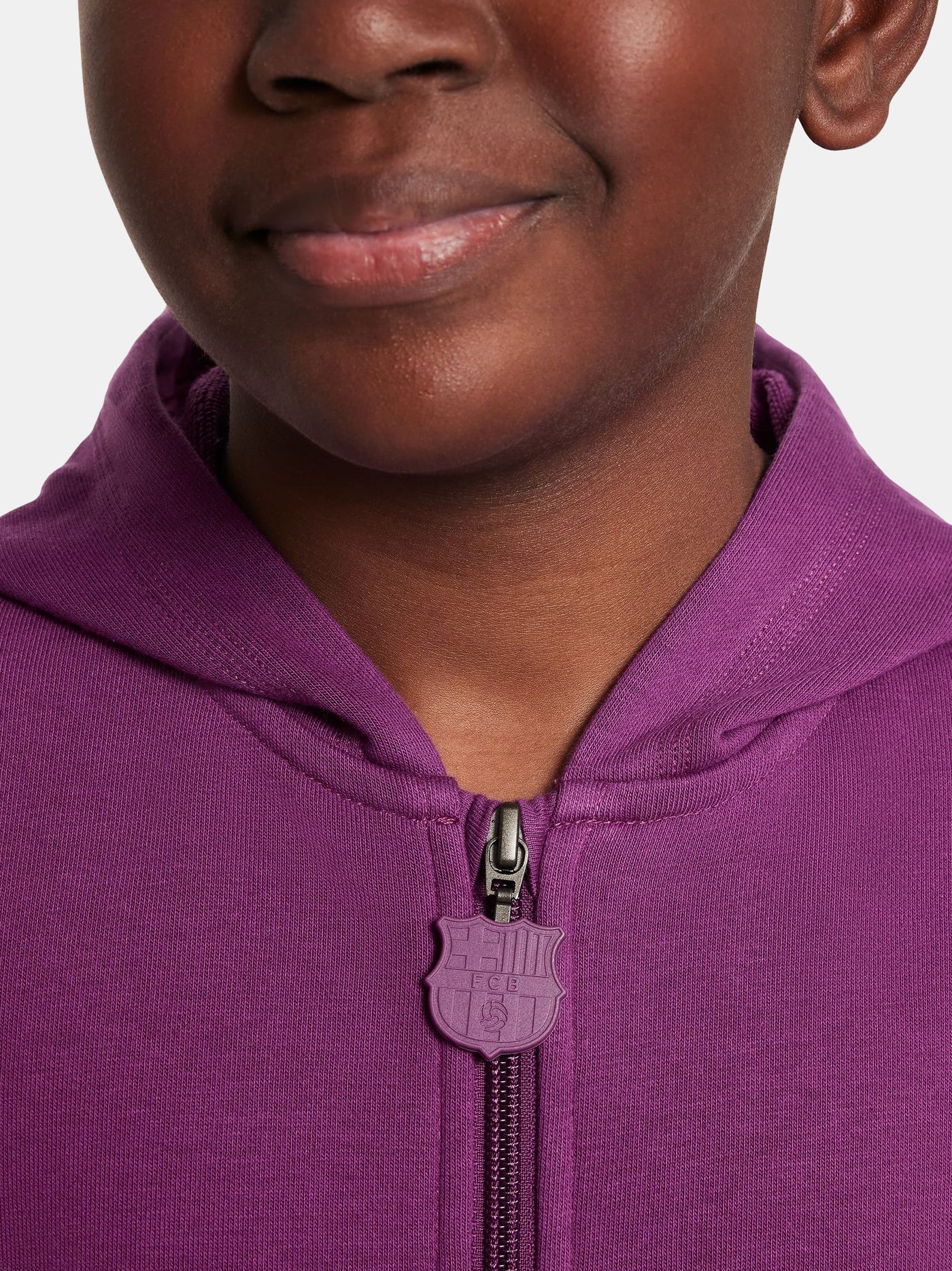 Close-up of a person wearing a purple hoodie with a brand logo on the chest area.