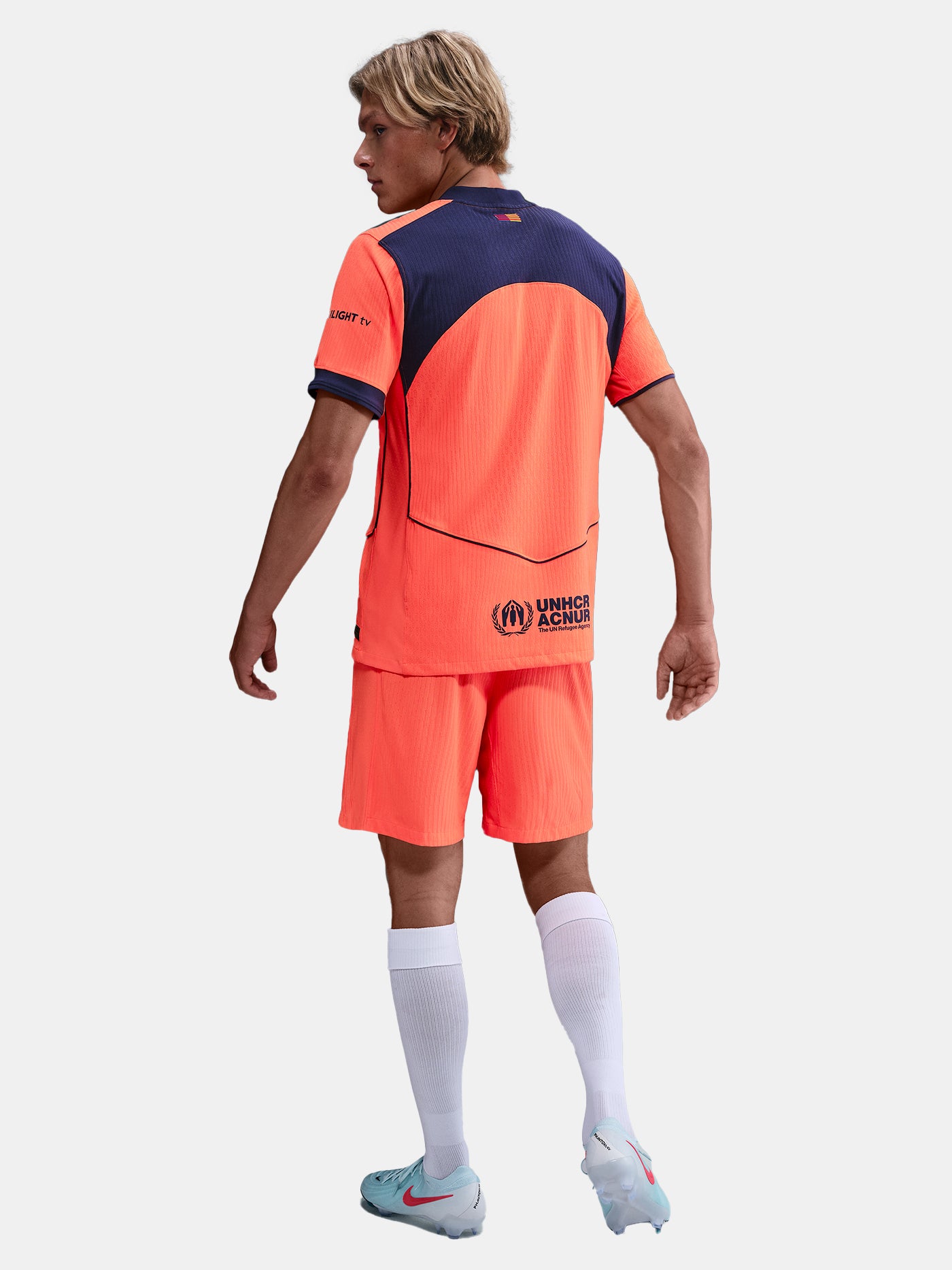 FC Barcelona third kit football shorts in orange with navy blue Nike logo and club crest