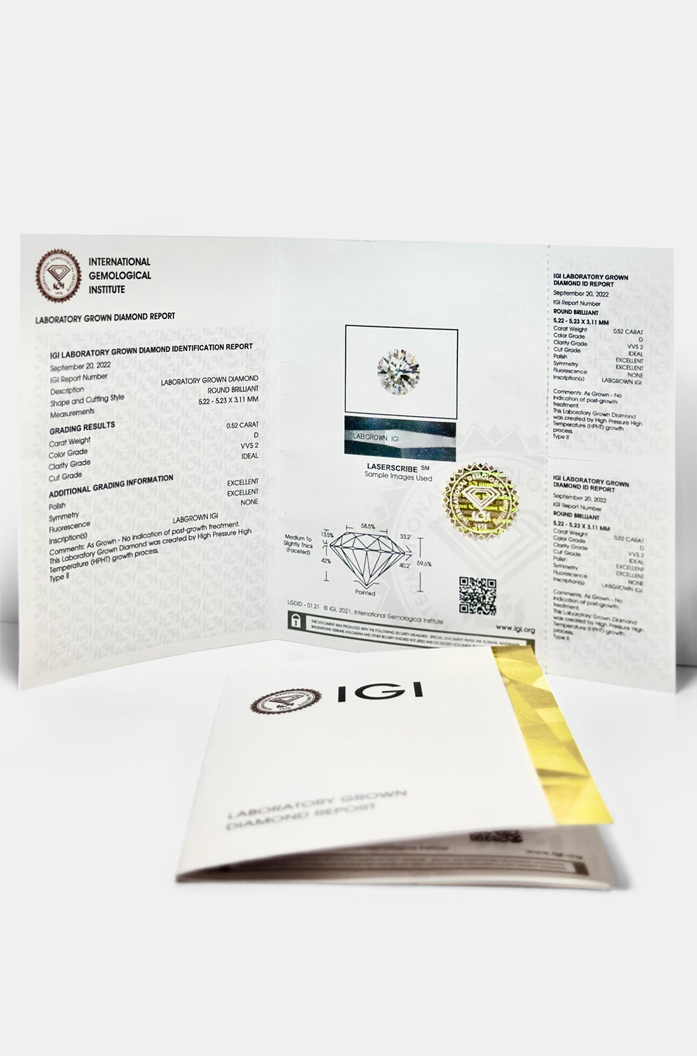 Open IGI diamond certification report with grading details and image of a lab-grown diamond, accompanied by a folded certificate envelope.
