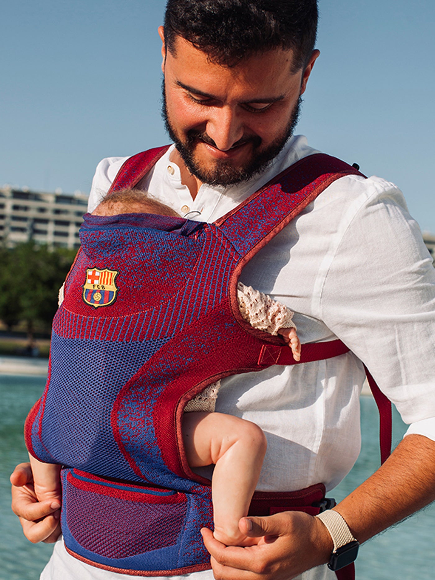 red and blue FC Barcelona baby carrier featuring the club's crest.