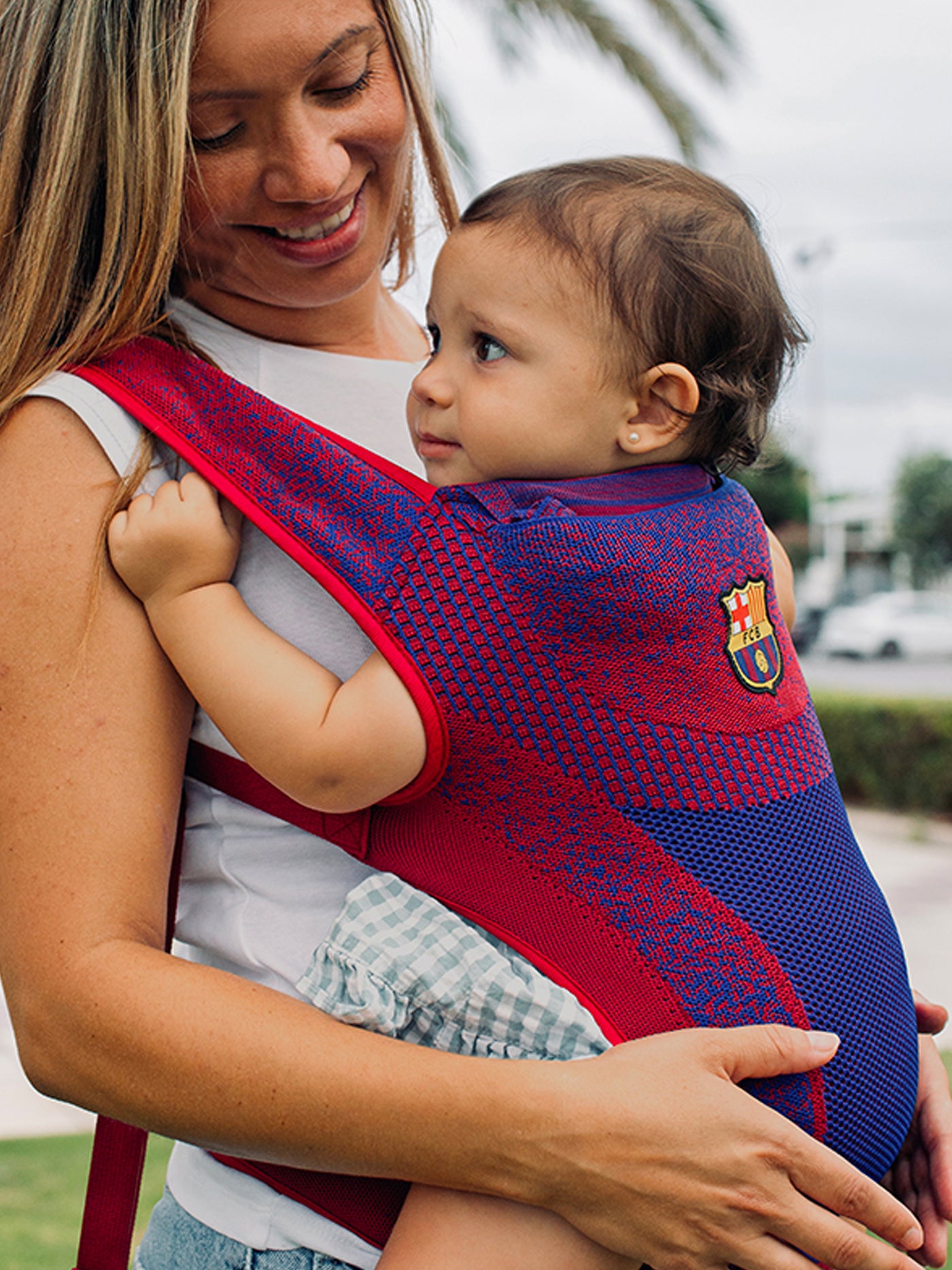 red and blue FC Barcelona baby carrier featuring the club's crest.
