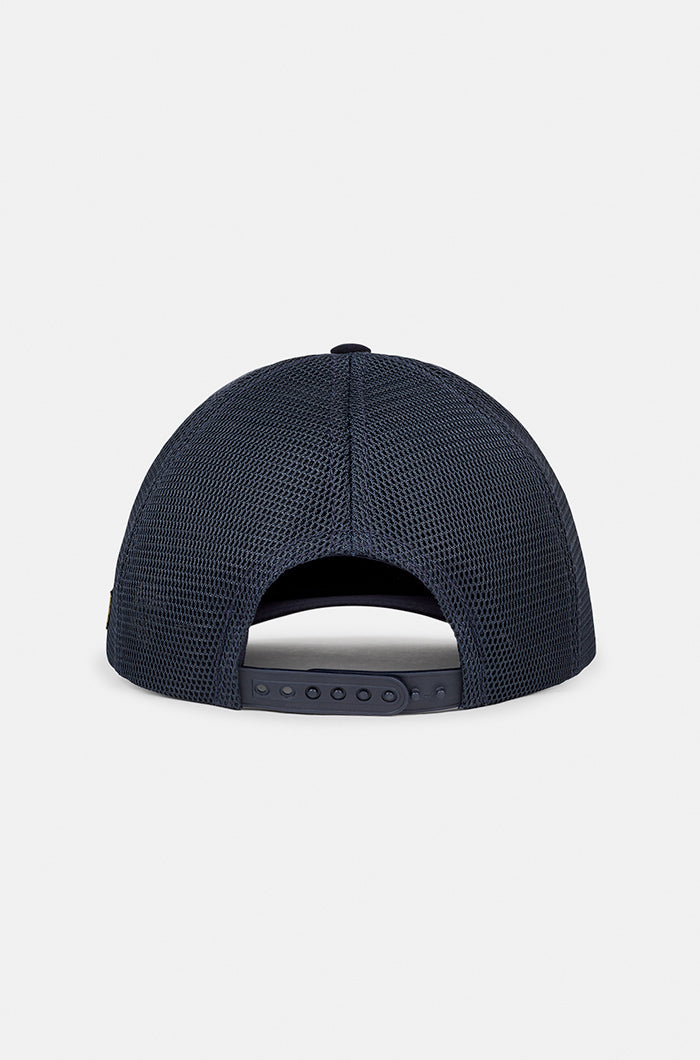 Navy blue FC Barcelona trucker cap with mesh back, embroidered club crest patch on the front panel, and the word “BARÇA” in yellow on the side.