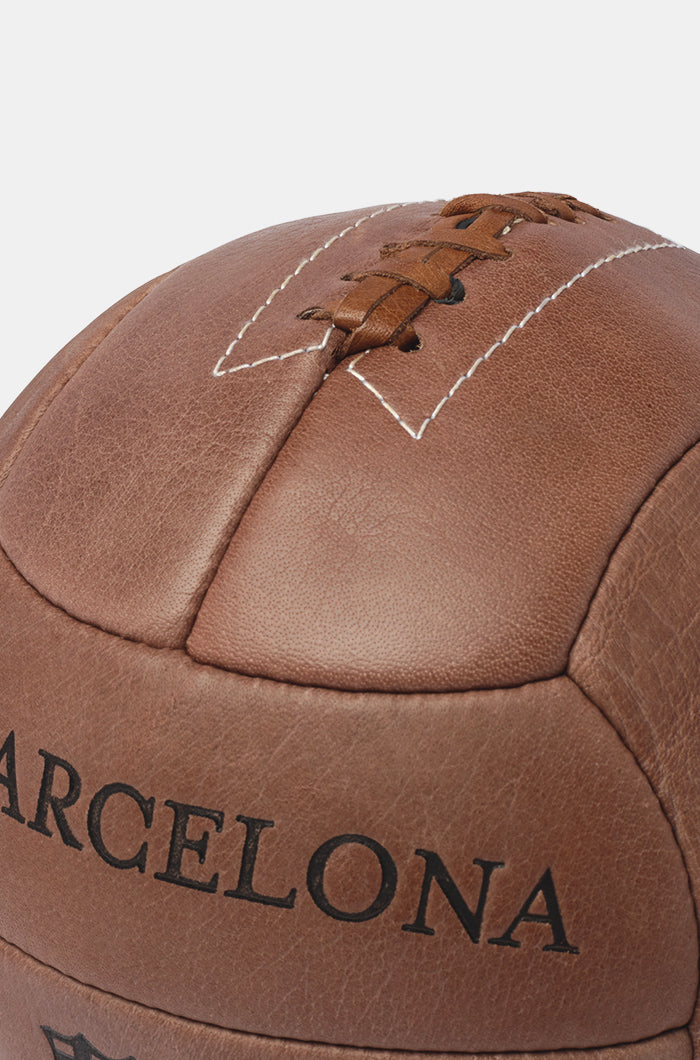 Vintage-style brown leather football featuring the F.C. Barcelona name and an old version of the club crest in black