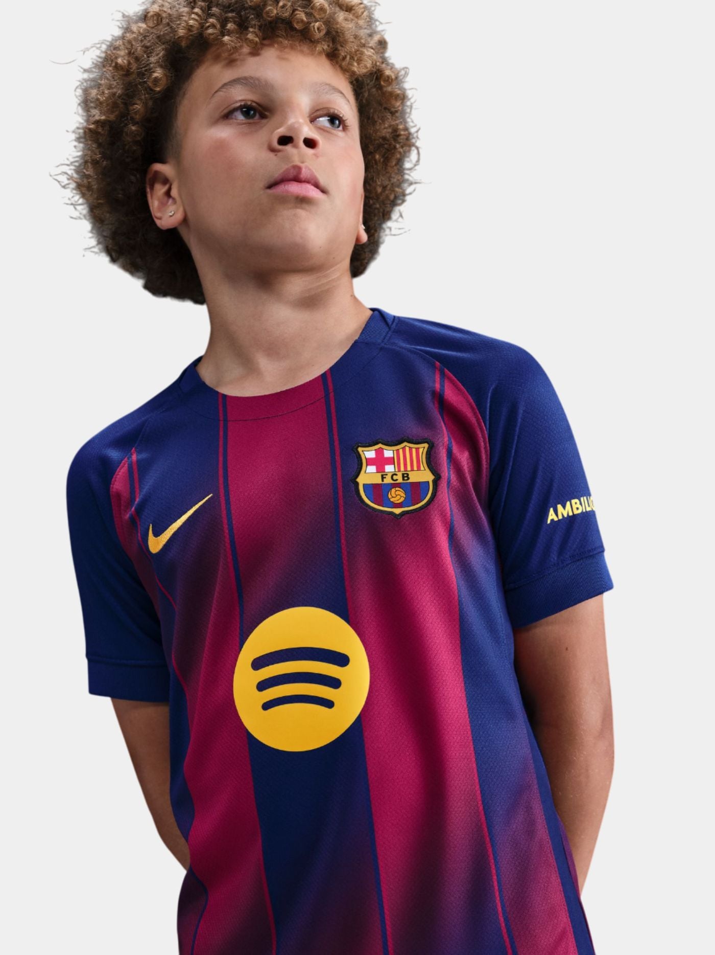 FC Barcelona home jersey with blue and red vertical stripes, featuring the club crest, Nike logo, Spotify sponsor in yellow, and Ambilight branding on the sleeve