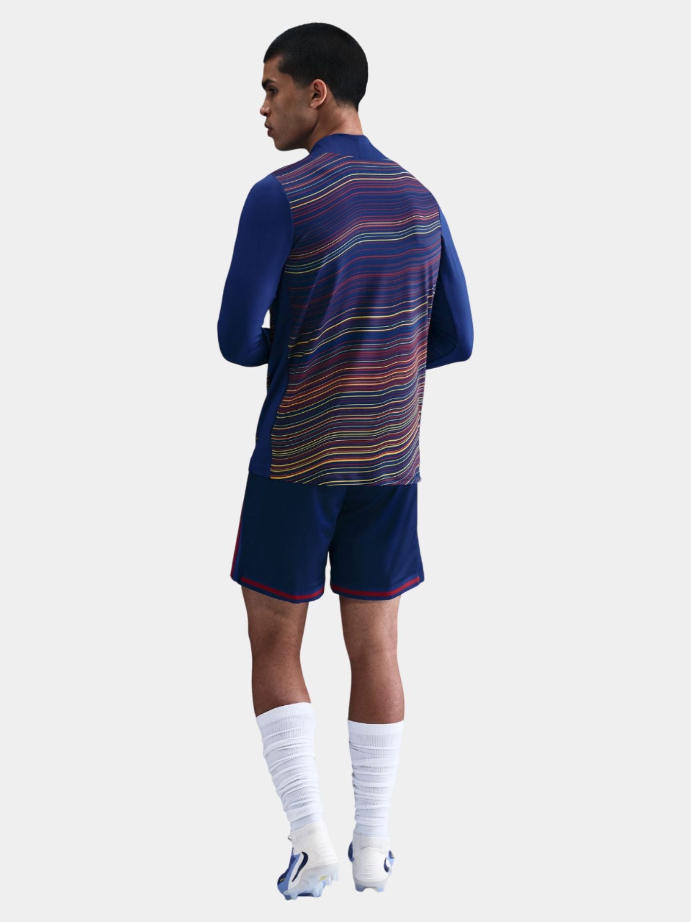 Person wearing a blue sports outfit with a patterned back on a white background