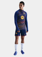 Person wearing a blue sports outfit with a colorful pattern on a white background