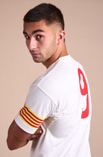 White T-shirt with FC Barcelona crest on the chest, Catalan flag detail on the sleeve, and red number 9 on the back.