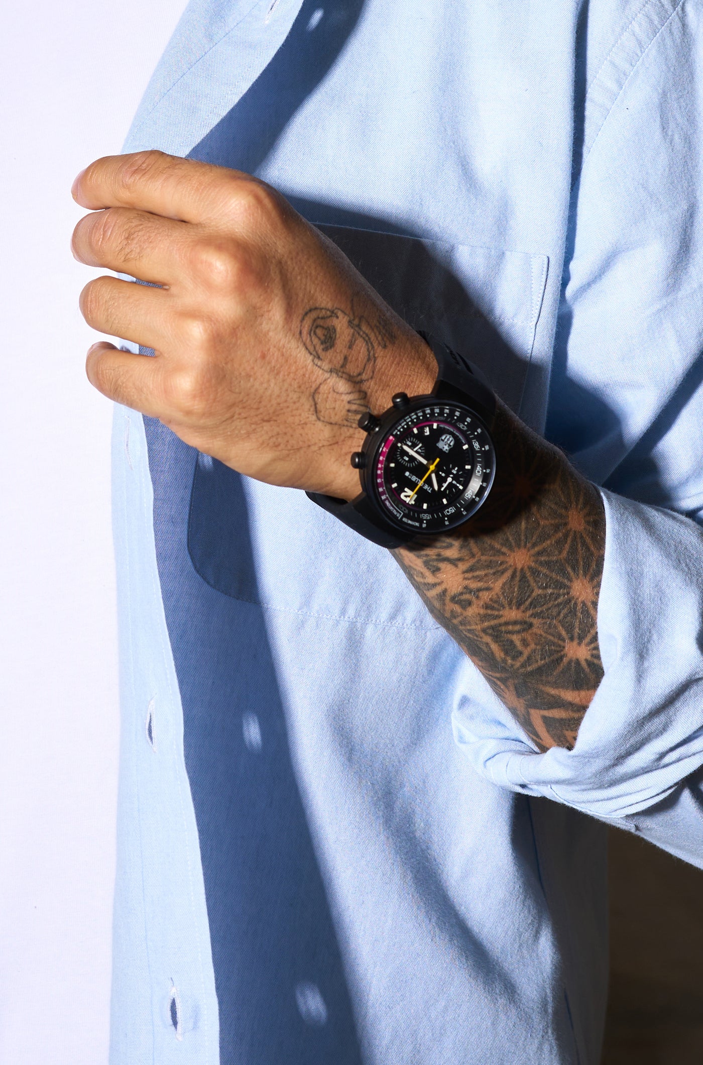 Black wristwatch with FC Barcelona crest, displayed in a black presentation box, featuring a dark dial with red and blue accents and a yellow second hand