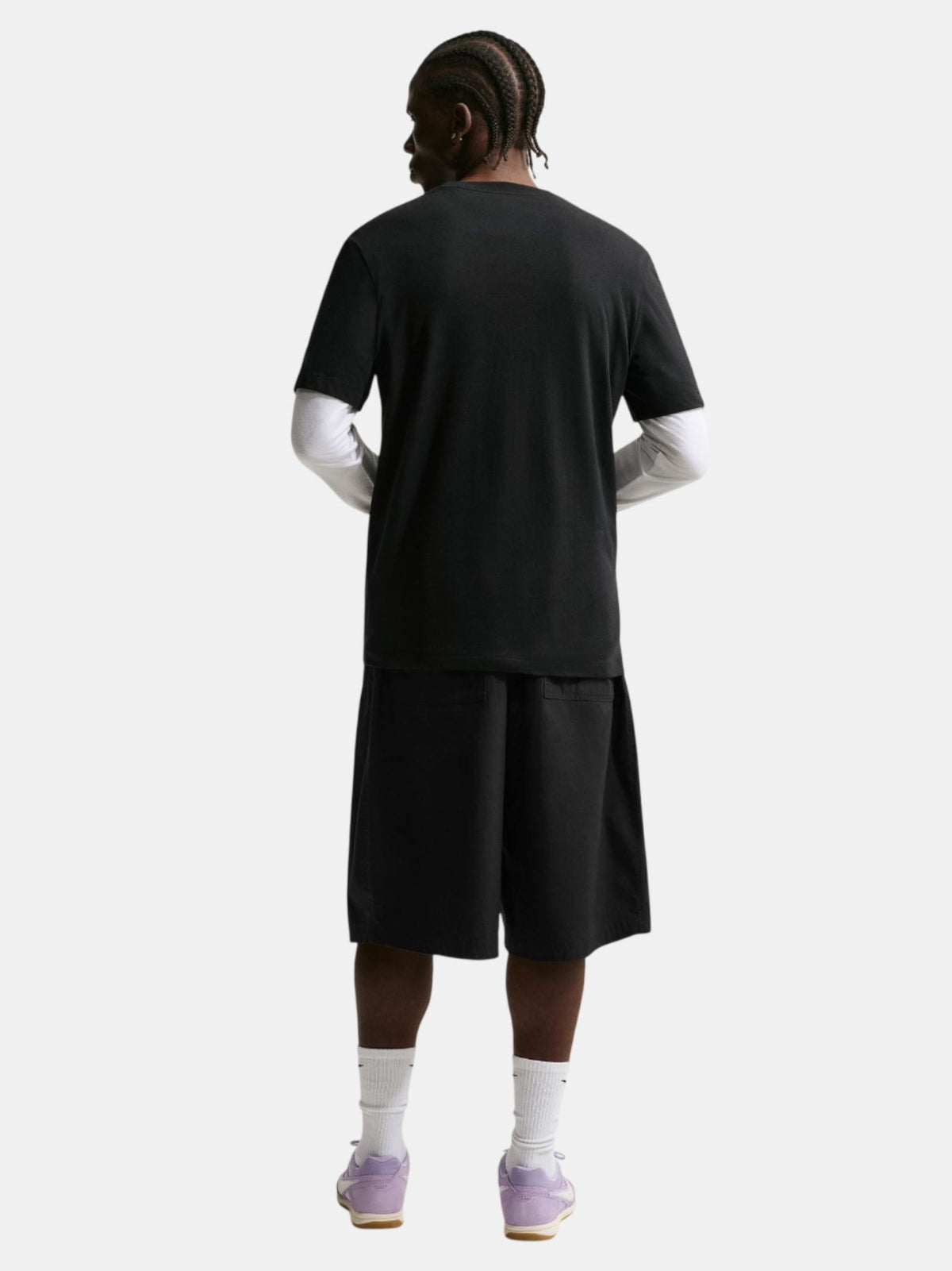 Person wearing a black t-shirt and shorts set on a white background