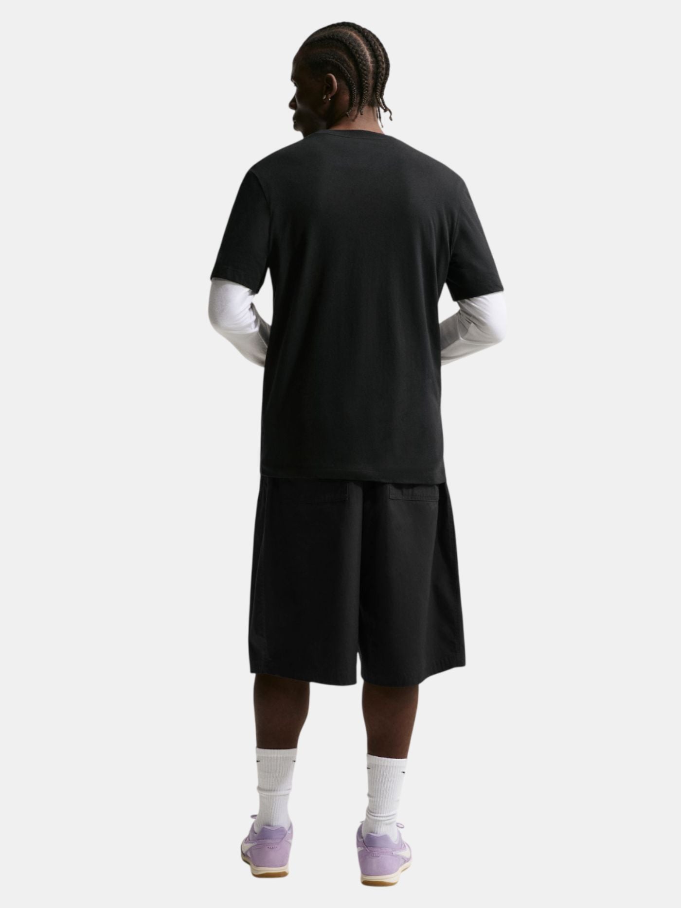 Person wearing a black t-shirt and shorts set on a white background