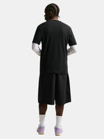 Person wearing a black t-shirt and shorts set on a white background