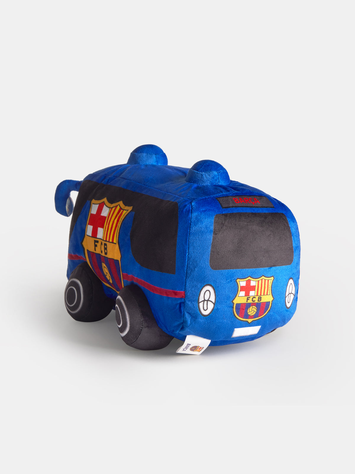 Juguete de peluche azul con forma de autobús de FC Barcelona, con escudos del club, ventanas negras y ruedas.