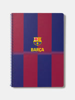 Red and blue striped spiral notebook with FC Barcelona crest and 'Barça' text on the cover