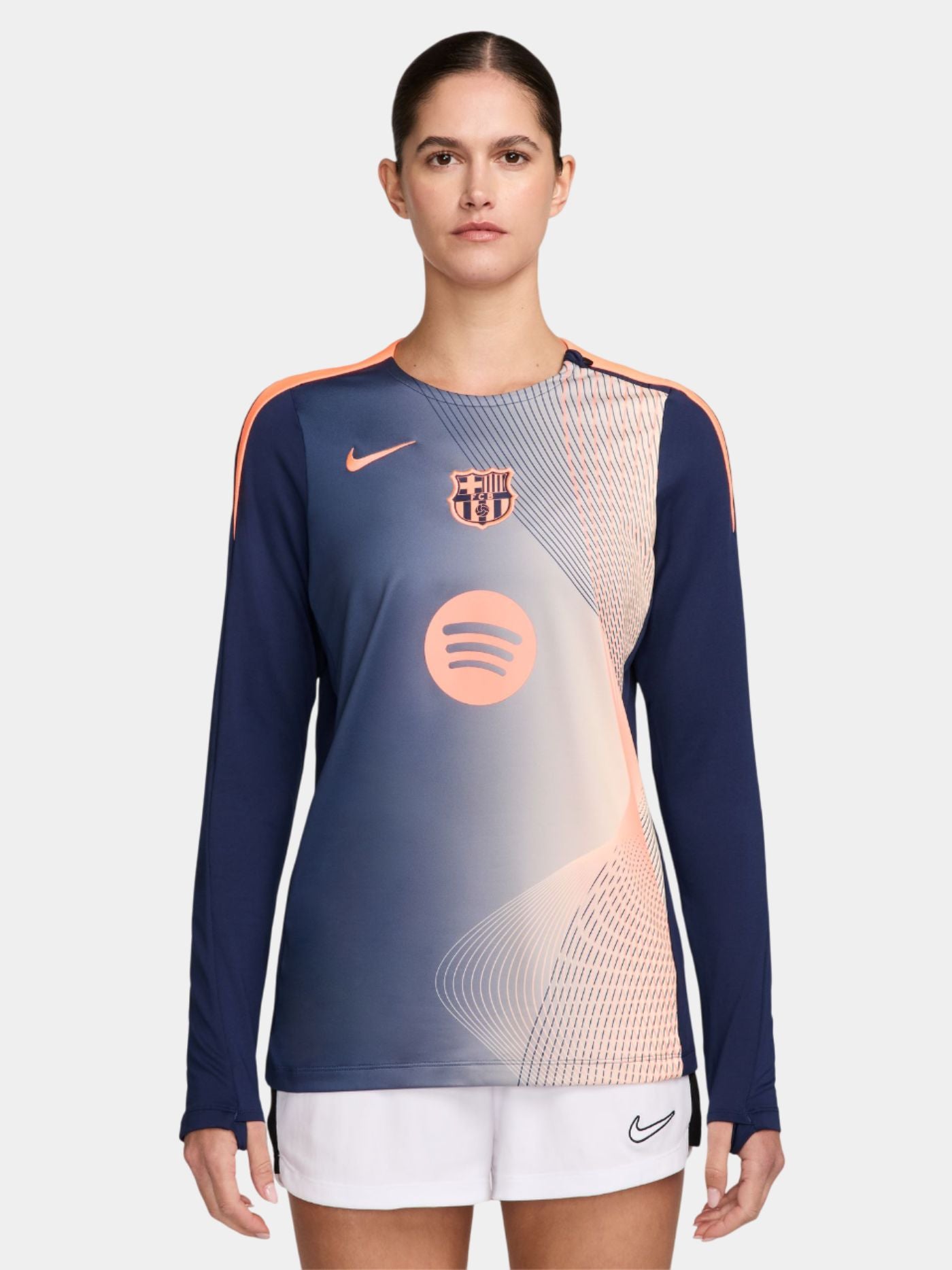 navy FC Barcelona jersey with coral geometric design, featuring the club crest, Nike logo, and Spotify sponsor.