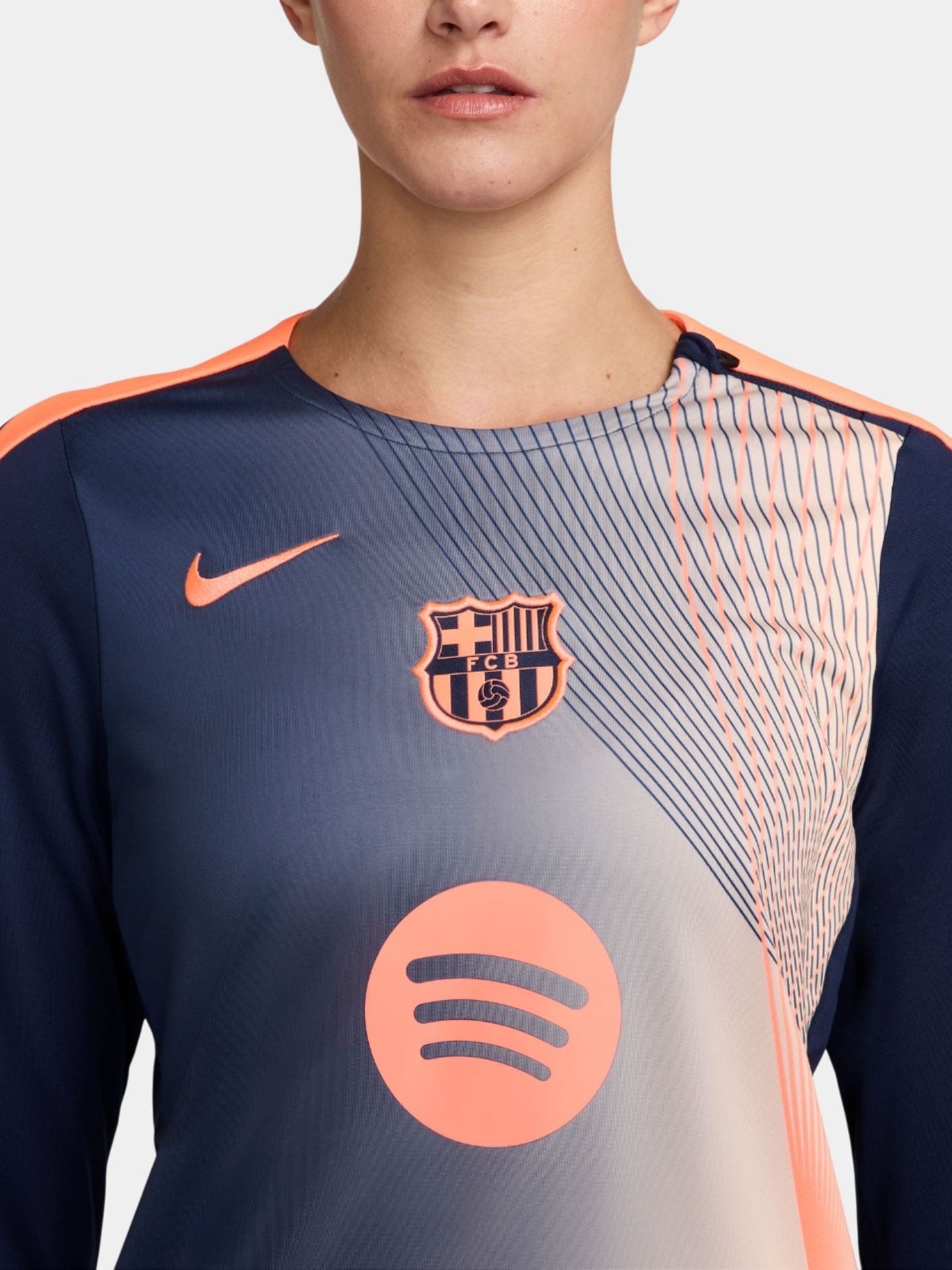 navy FC Barcelona jersey with coral geometric design, featuring the club crest, Nike logo, and Spotify sponsor.