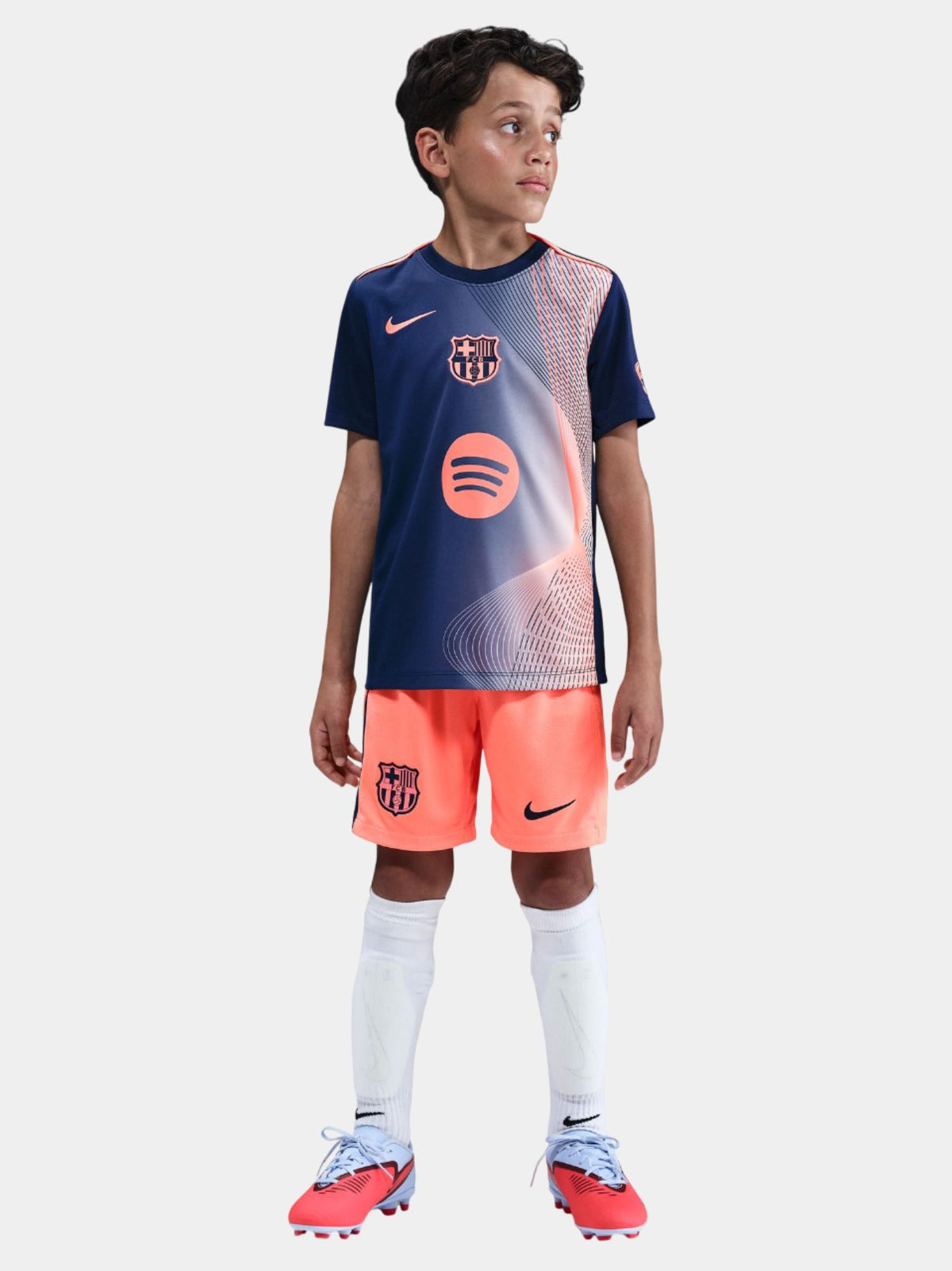 navy FC Barcelona jersey with coral geometric design, featuring the club crest, Nike logo, and Spotify sponsor.