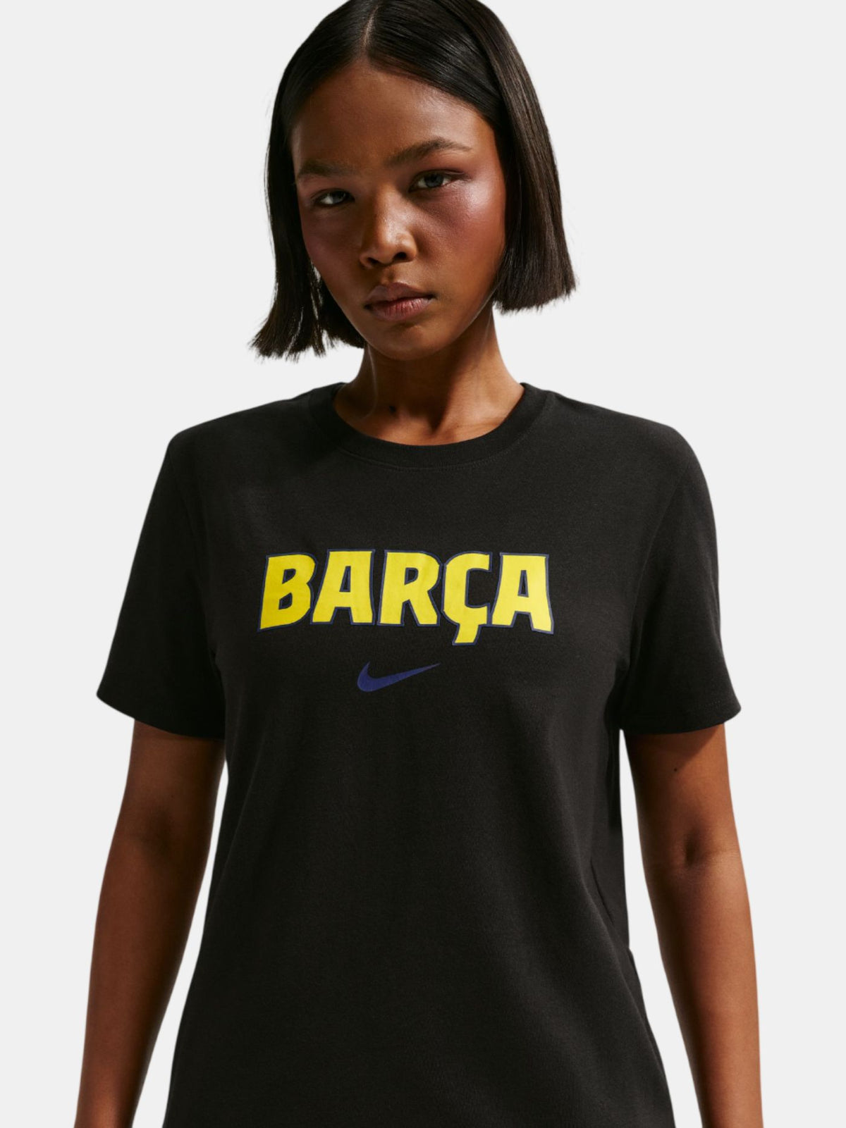 Person wearing a black t-shirt with 'BARÇA' and Nike logo on a white background