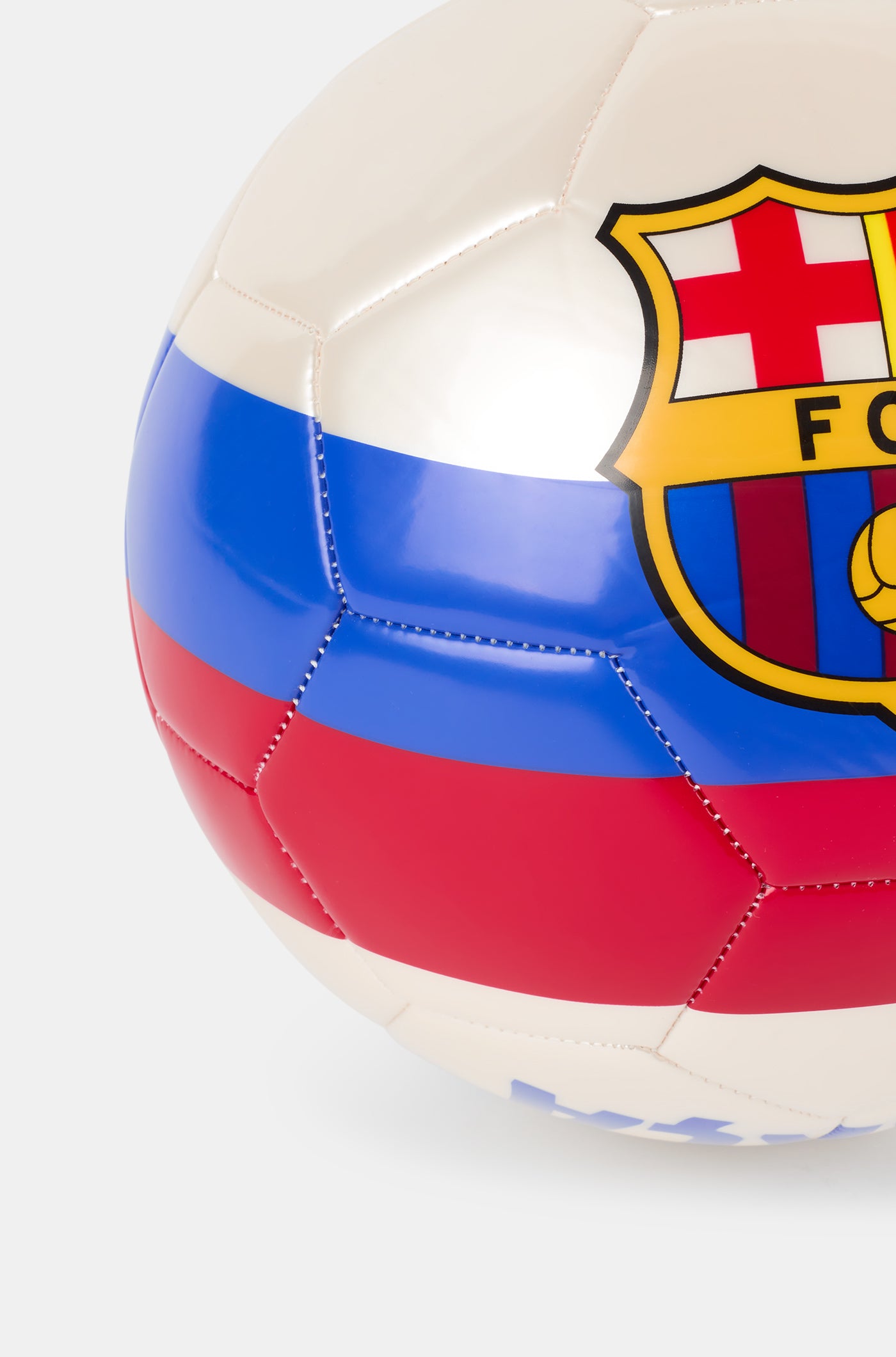 White football with blue and red stripes, featuring a large FC Barcelona crest in the center