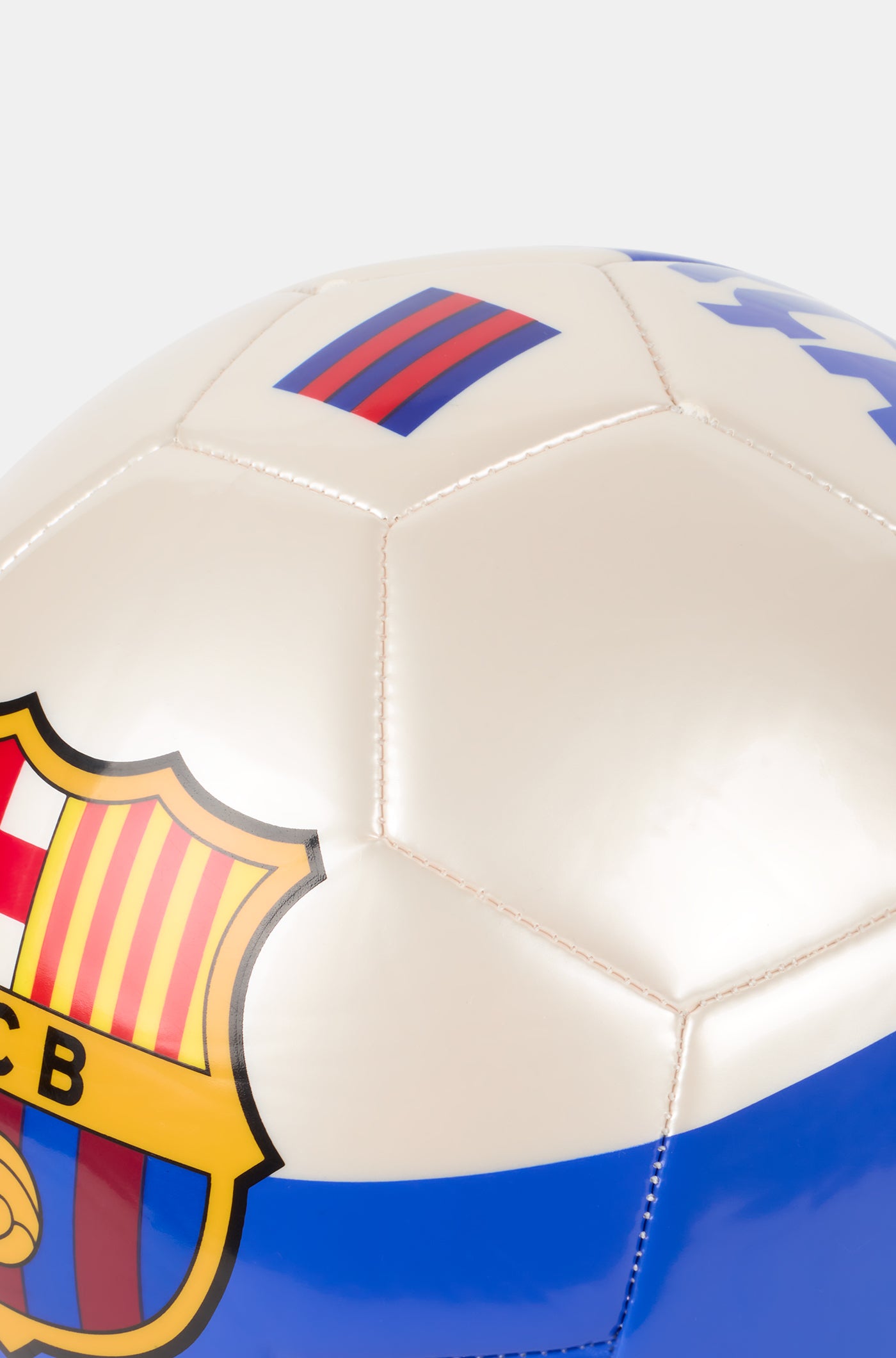White football with blue and red stripes, featuring a large FC Barcelona crest in the center