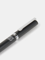 Black and silver pen featuring an engraved FC Barcelona crest on the barrel.