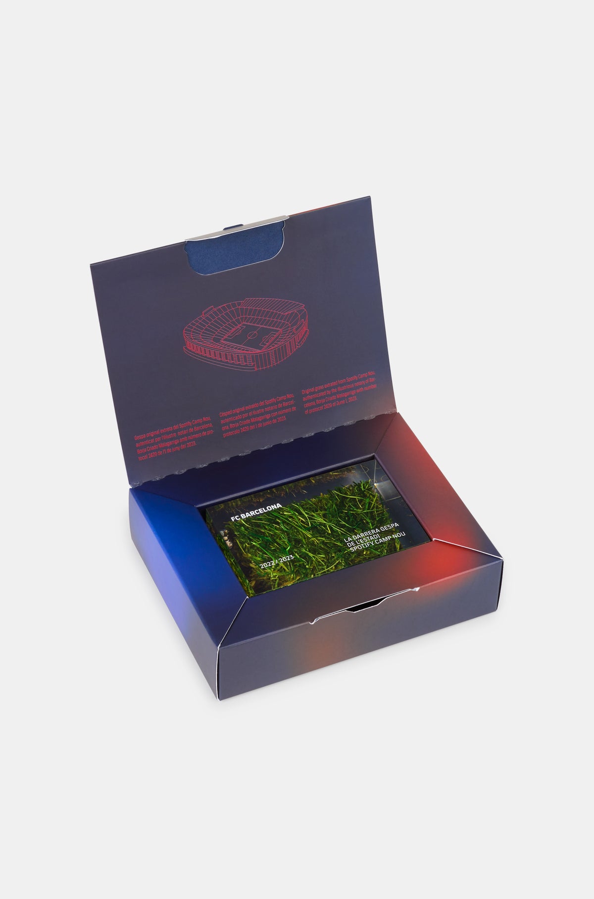 Rectangular acrylic display block encasing a preserved piece of grass from FC Barcelona's stadium. The block is engraved with the text "FC BARCELONA", "2022 / 2023", and "LA DARRERA GESPA DE L'ESTADI, FONT CAMP NOU", commemorating the last season played at the historic Camp Nou before renovations.
