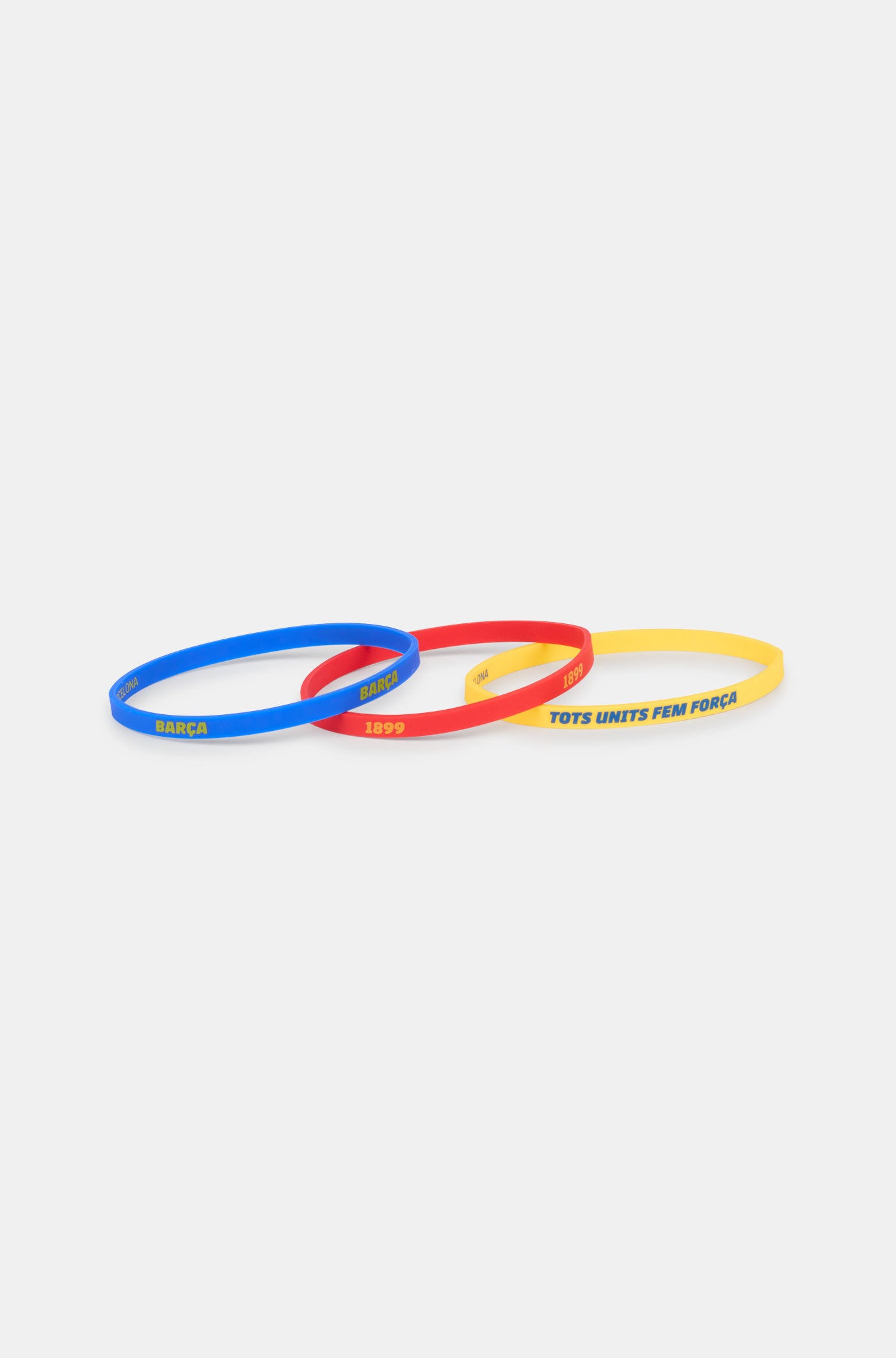 Set of three silicone wristbands in blue, red, and yellow, featuring FC Barcelona-related texts like 'BARÇA', '1899', and 'TOTS UNITS FEM FORÇA