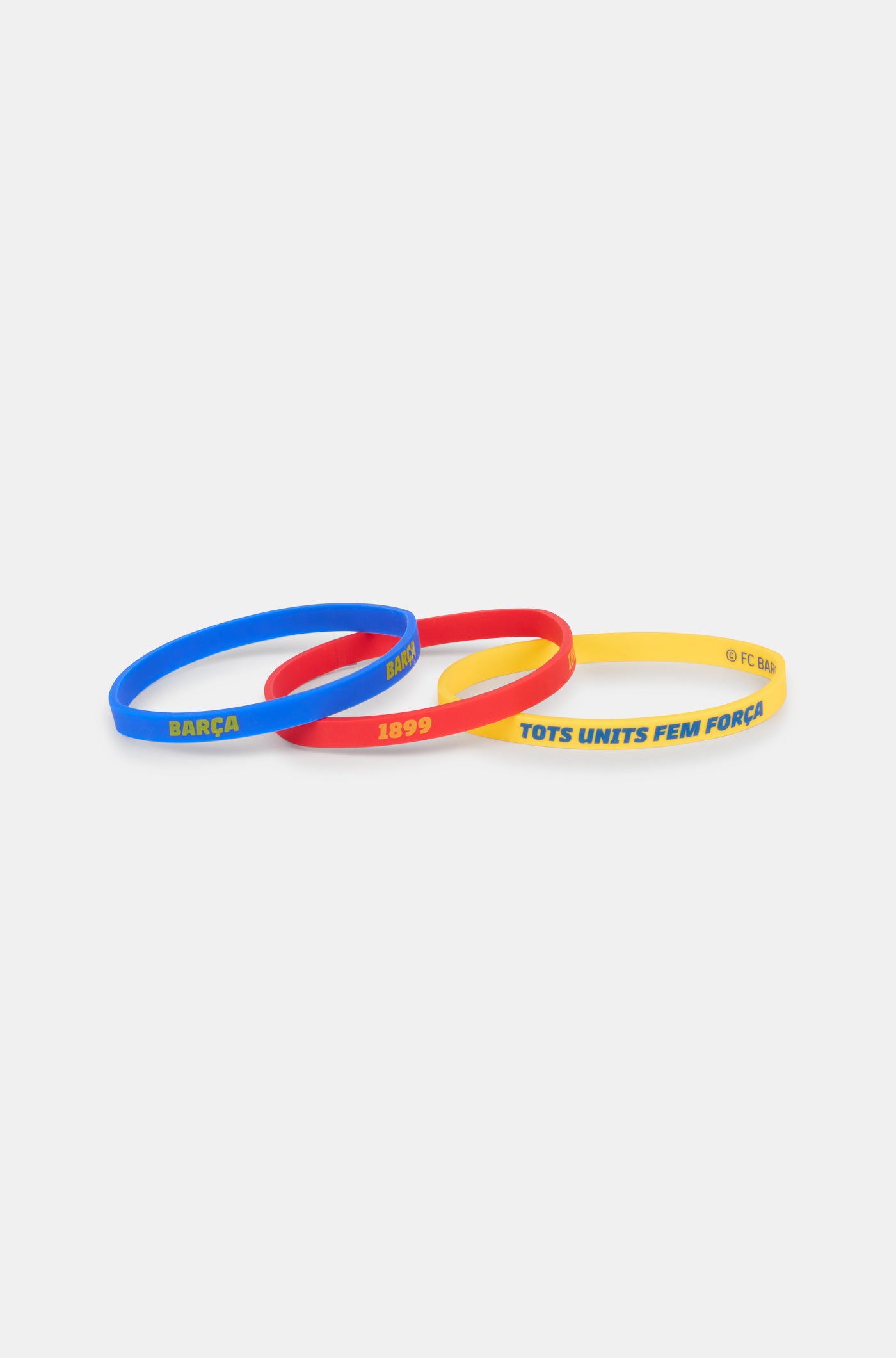 Set of three silicone wristbands in blue, red, and yellow, featuring FC Barcelona-related texts like 'BARÇA', '1899', and 'TOTS UNITS FEM FORÇA