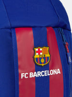 Blue backpack with vertical maroon stripes, featuring the FC Barcelona crest and 'FC BARCELONA' text on the front