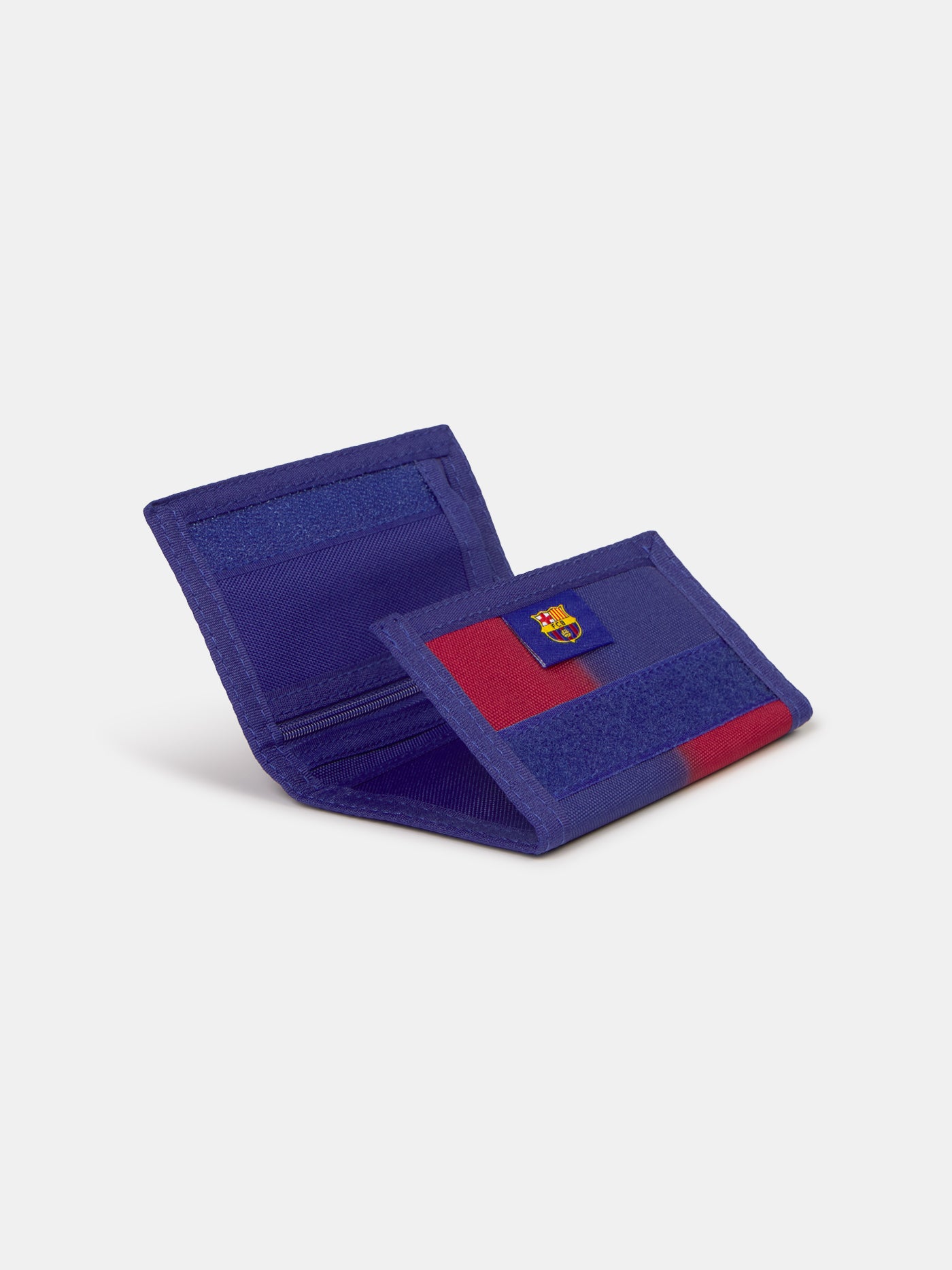 Blue and red fabric wallet with yellow 'Barça' text, displayed in FC Barcelona branded packaging