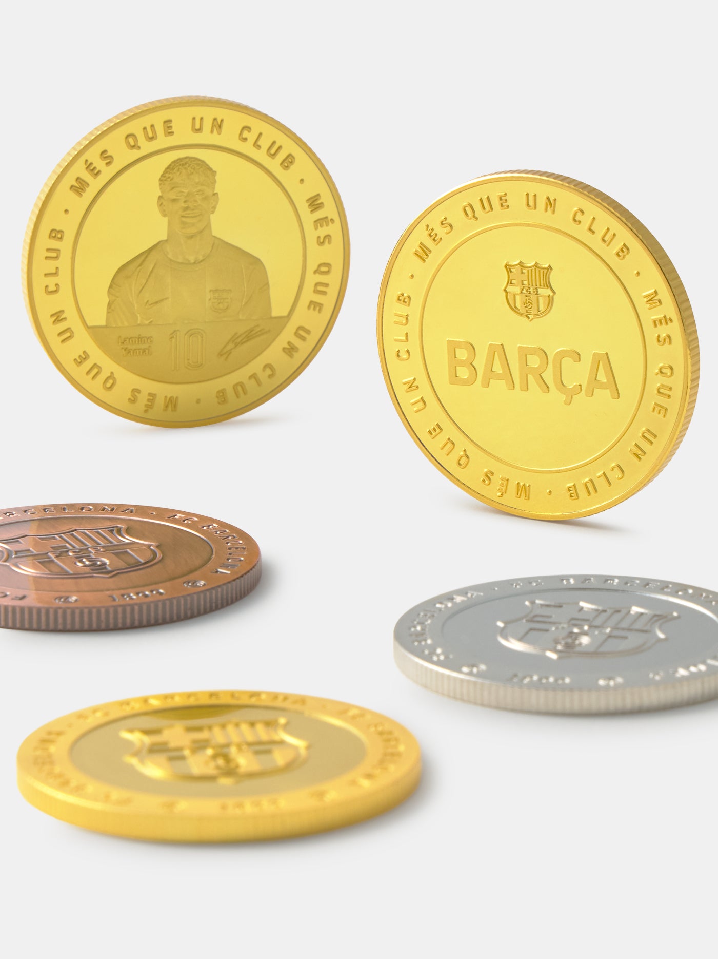 Set of gold, silver, and bronze coins with a prominent 'BARÇA' logo on a white background.